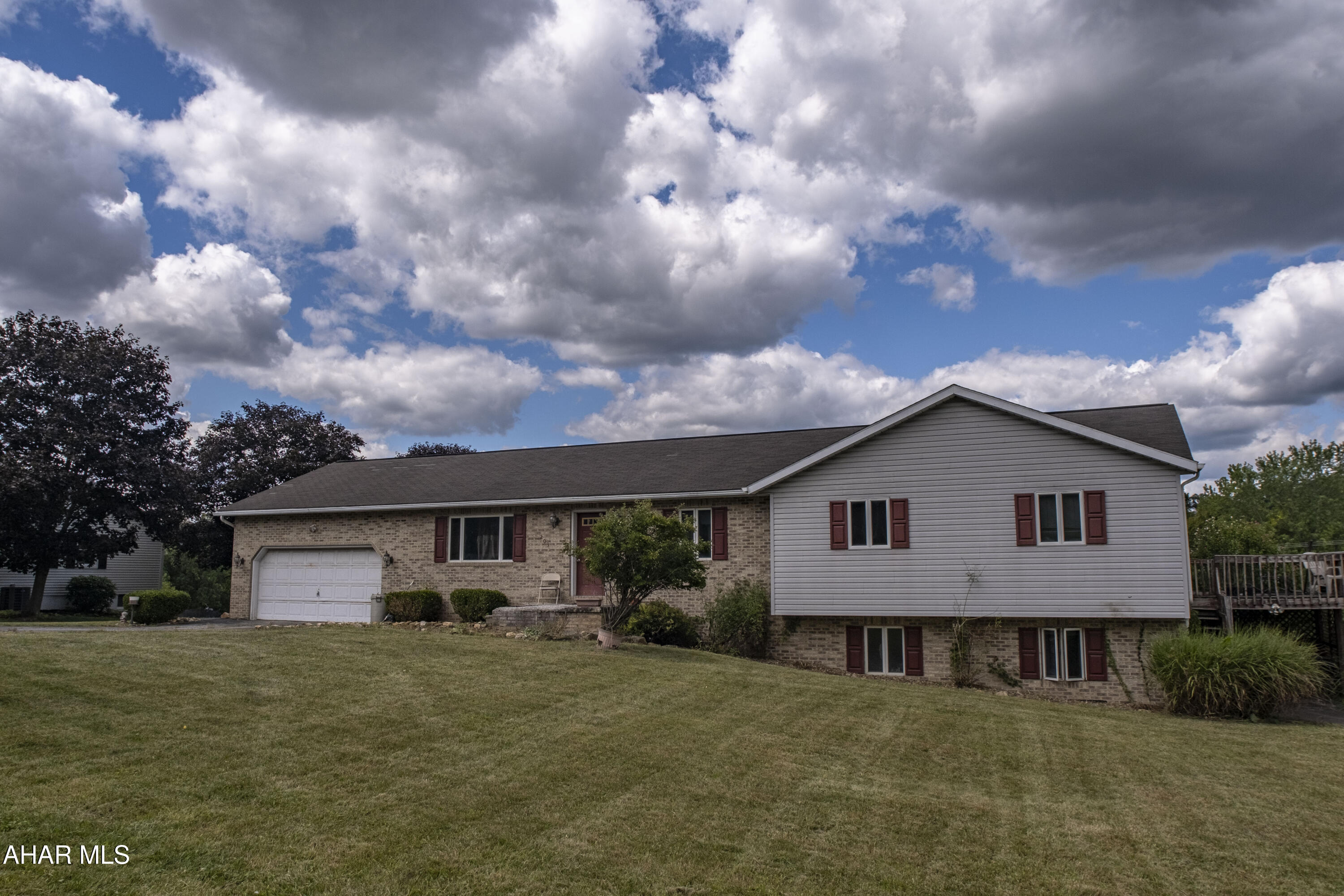 This brick ranch home, with a total of five bedrooms and three full baths, offers a solid foundation for its next owners.The home's entrance is marked by a large foyer that welcomes you in. The main floor features a gently used open-concept eat-in kitchen and living room that flow into a comfortable family room, providing a versatile layout for everyday living. Convenience is key, with a laundry room also located on this level.

The main bedroom suite includes a private master bathroom, a large walk in closest and walkout deck. 
While this home has excellent bones and a lot of potential, it could use a little TLC to bring out its full charm. Some cosmetic updates would easily breathe new life into the interior.
A 2 car garage attached and a large yard makes this home. Schedule a tour.