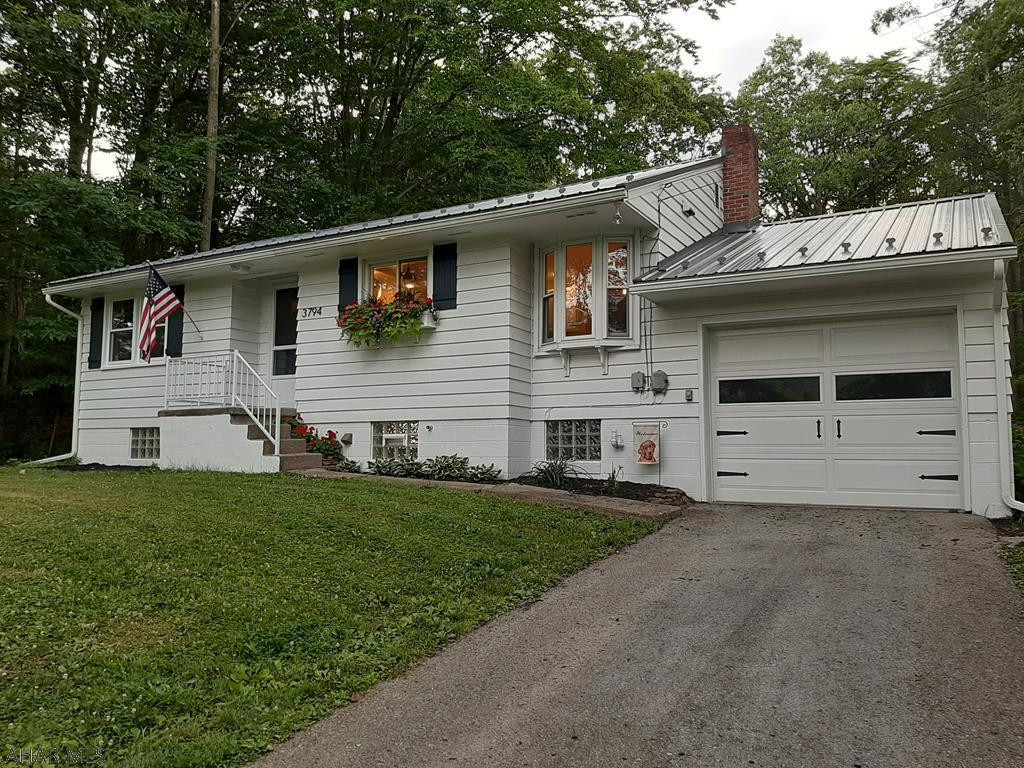 PRIVATE, SINKING VALLEY BUNGALOW.  This adorable 1-story home has great curb appeal, a newly remodeled kitchen and bathroom, a propane gas fireplace, hardwood floors, updated light fixtures and ceiling fans, central air, an attached 1-car garage, and a detached 2-car garage.  The house and garage are surrounded by mature trees on three sides.  It really is sweet!  If you're interested, don't delay.  Call today to schedule a tour.