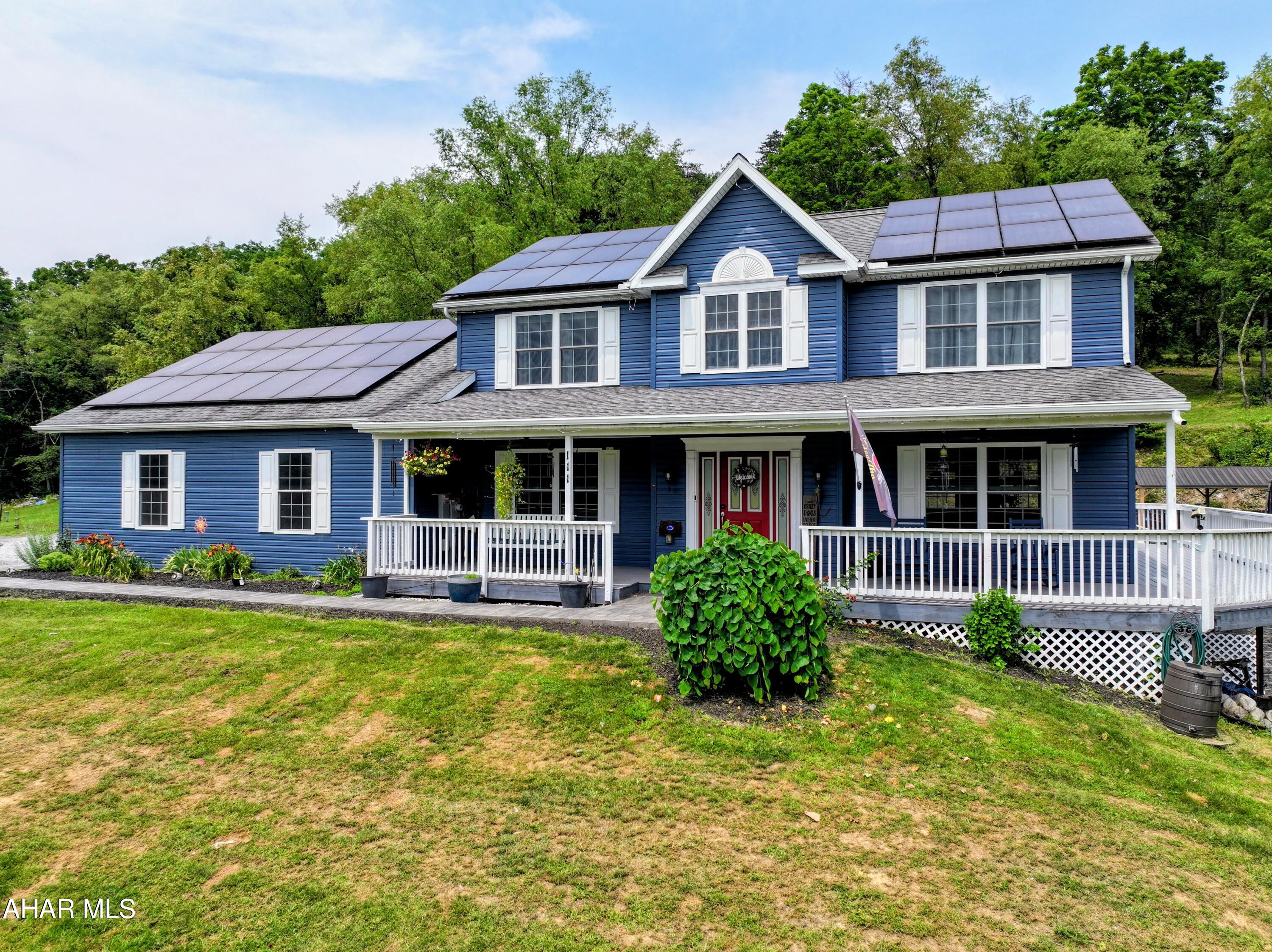 Experience exceptional craftsmanship, modern efficiency, and breathtaking views in this custom-built, one-owner home, thoughtfully designed in 2016 and situated on 4.43 picturesque acres. Offering the perfect blend of luxury, comfort, and functionality, this remarkable property is just minutes from State Game Lands, Bellefonte, and State College.

A welcoming wraparound porch sets the tone as you step inside to discover a spacious floor plan designed for both everyday living and entertaining. The inviting living room features built-in surround sound, while the formal dining room provides an elegant setting for special occasions. The kitchen is beautifully appointed with granite countertops, premium soft-close cabinetry, and exceptional storage, including both a walk-in pantry and an additional pantry. A convenient half bath and direct access to the attached three-car garage, complete the main level.

Step outside to your own private backyard retreat. The expansive stamped concrete patio is designed for entertaining and relaxation, featuring a built-in fire pit, separate covered seating and grilling areas, a heated saltwater in-ground pool installed in 2024, and a dedicated play area--all surrounded by stunning mountian views.

The finished lower level expands the living space with a spacious family room featuring walk-out access, a versatile office or playroom, a ¾ bath, an exercise room, and abundant storage.

Upstairs, the luxurious primary suite offers a peaceful escape with a walk-in closet and an elegant ensuite bath featuring double vanities. Three additional oversized bedrooms, a full bath, and a conveniently located second-floor laundry room provide ample space for family and guests.

Designed with energy efficiency in mind, the home is powered by solar panels installed in 2022, complemented by an efficient heat pump water heater and a smart thermostat for modern comfort and cost savings.

Combining luxury finishes, energy-efficient technology, exceptional outdoor living, and an unbeatable location, this extraordinary property offers a rare opportunity to enjoy refined country living without sacrificing convenience.
