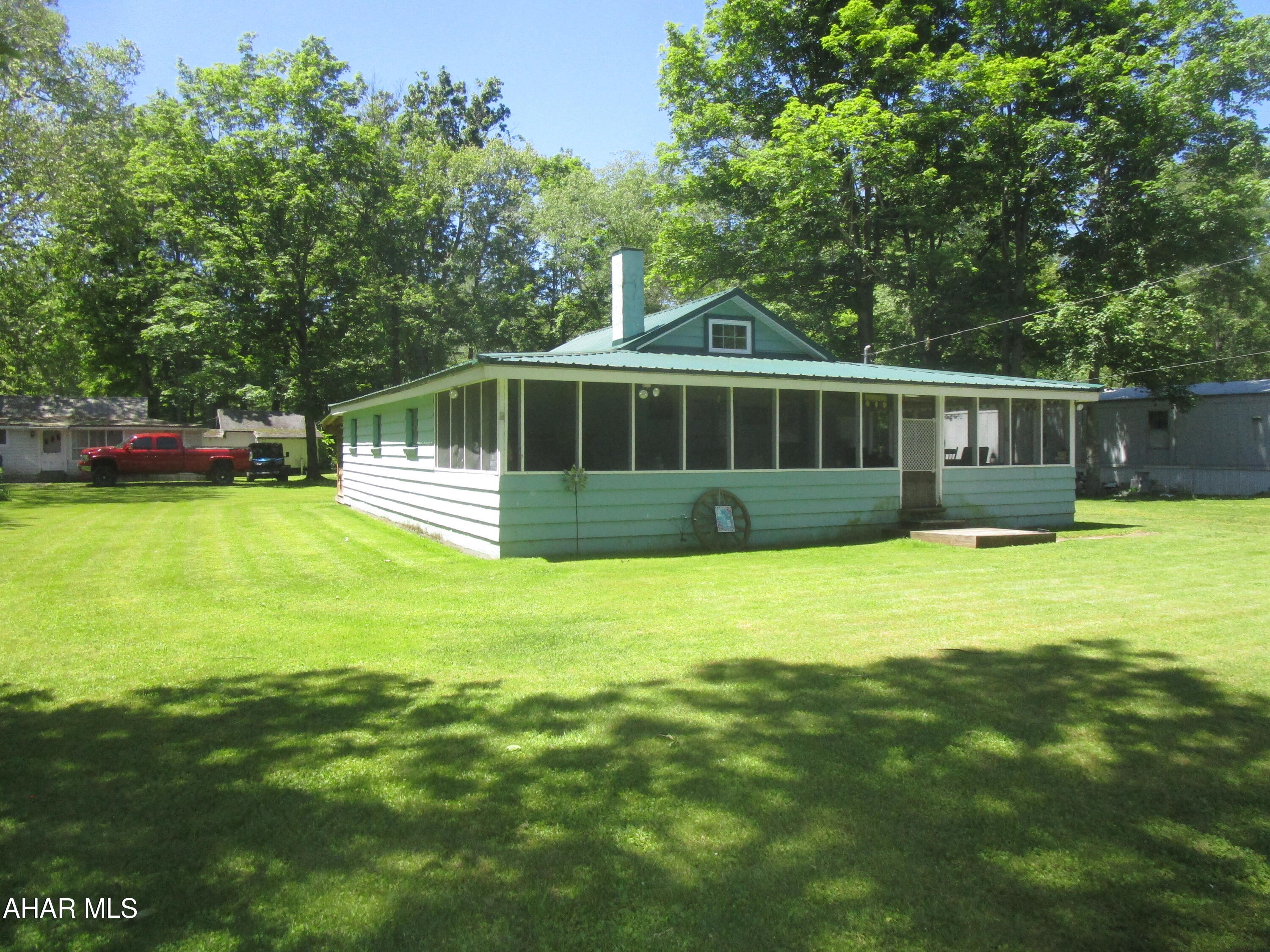 A ''move-in-ready'',  furnished cottage on a nice 0.413-acre, corner lot with Dunning Creek accesses + a cozy fire pit & the ''gnome's house''.  The cottage is very appealing with unique, open rafter ceilings; 3 BR; full bath; combo laund./entry/stg. rm; kitchen; &, a spacious living rm.!  You will love the furnished, screen.-in porch in addition to the rear porch equipped with grills & a motorcycle ramp.  Newer  insulated metal roof & a mini-split heating/cooling unit. This is a ''must-see''!
Buyers to confirm taxes, SF, lot size, restrictions.
Some restrictions attached; however,  there may be additional restrictions.
To be sold as-is & a cash transaction.