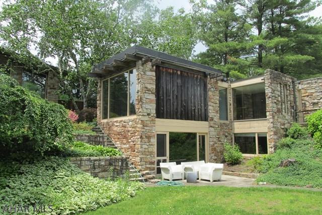 Beautiful stone and cedar contemporary - Frank Lloyd Wright style, LR, DR, kitchen, bar room, MBR, MBA, BR 2, BR 3, full BA, laundry. Lower level FR, BR 4, full BA, utility room, physical plant.  Amenities: skylights, landscape, lighting, cedar closets, Travertine marble bathrooms, closets w/built-ins and shelving, floor to ceiling windows, 20 ft ceiling in great room, butlers pantry w/lined drawers, cork floors in kitchen, large in ground pool, small orchard w/fruit bearing trees, picnic area, 3 car garage, pocket doors, pegged oak floors in great room, new carpet, storage, 3 furnaces, multiple zones, water softener, 2 hot water tanks, central vac.