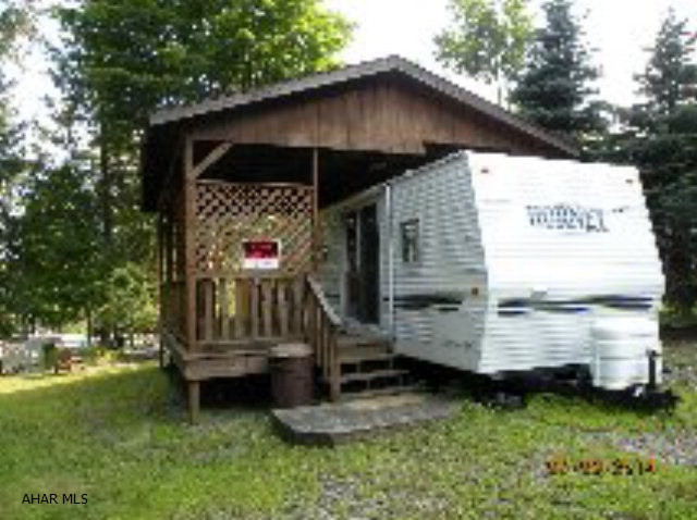 Well maintained camper w/ pavilion & shed. Nice covered deck