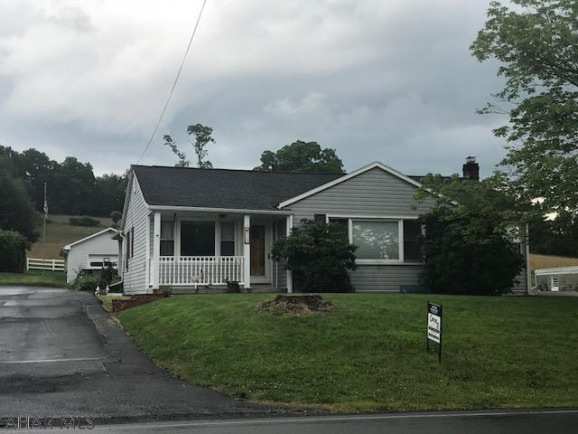 3 bedroom ranch style home with one car detached garage and  carport. covered front and back porch. newer windows and siding. hardwood floors. full basement, central air and hot water heat.