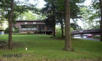 RUSTIC PRIVATE SETTING CLOSE TO ALL AMENITIES.  RUSTIC PRIVATE SETTING, 2.5 CAR GARAGE W/LOFT. HOME HAS VAULTED CEILINGS, OPEN BALCONY, NEW KIT. W/ISLAND. 20 MIN. FROM ST. COLLEGE & ALTOONA. 1/2 ACRE. SCREENED IN DECK, 2 GAS FIREPLACES. BAR IN GAME ROOM.