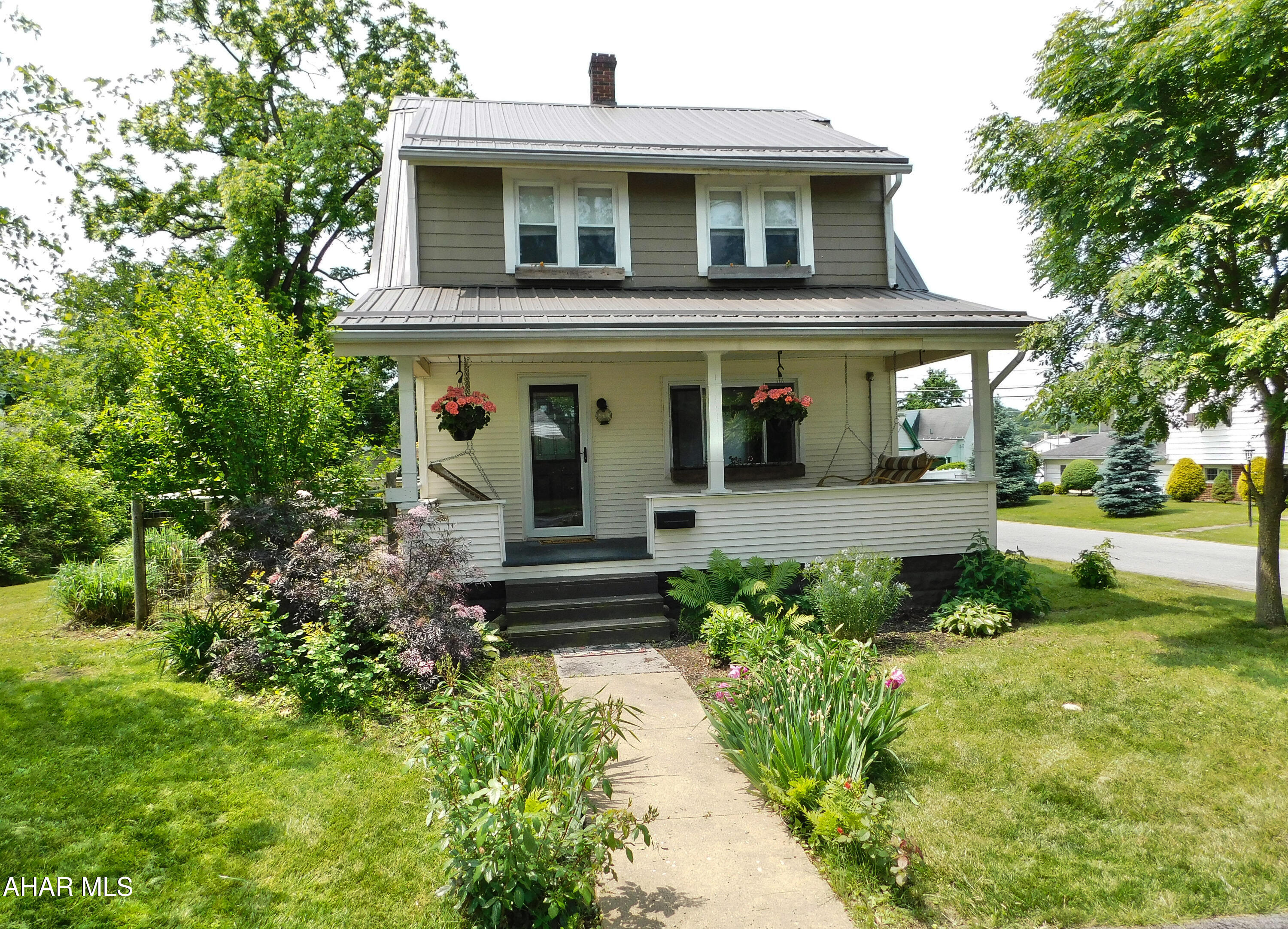 The most unique, one of a kind home is here!  On the outside you will love the beautiful landscaping and custom flower boxes.  Whether on the front porch or in the back yard, you will find an incredibly relaxing atmosphere.
Step inside and everywhere you look you are going to see custom work.  On each side of the gas fireplace you are going to find classic pocket doors that have been repurposed as stunning barn doors.  These doors are concealing convenient built in shelving.
The kitchen will leave you in awe.  The copper sink is the centerpiece of it all.  Concrete countertops and unique custom shelving highlight the character of this home.    The repurposed metal table has been converted into a beautiful breakfast island.
The home features cork floors on the first floor and hardwood floors in the bedrooms.
There is so much more about this home we can mention, but how about some important things like a BRAND NEW ROOF, a new furnace, new instant hot water heater, and even a new gas meter.
This home is truly one you must see to appreciate so call today to schedule your private tour!