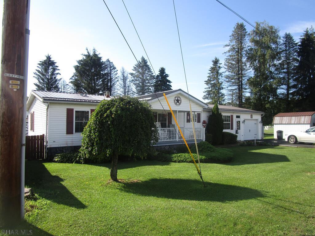 Very clean and well maintained double wide on a level lot. Home contains three bedrooms, living room with fireplace, eat in kitchen, laundry room and 1.75 baths. Attached 1.5 garage with paved driveway.  Screened in rear florida room type deck overlooks the park.