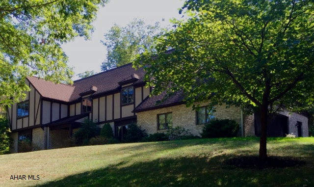This is a magnificent home with gorgeous panoramic views overlooking the Omni Bedford Springs Golf Course. A grand 2 story central foyer opens onto formal living, dining and kitchen areas. The designer inspired kitchen with granite counters opens onto a private stone terrace, family room and solarium. No detail has been overlooked in achieving the overall tranquility and peacefulness this space creates. The beautifully appointed bathrooms and bedrooms make this a must see home. Finished rec room, paved driveway and 2 car attached garage complete this stunning home surrounded by nature.