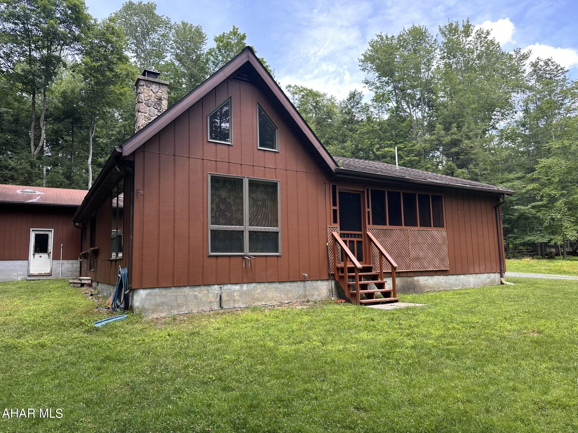 Great Cape Cod dwelling located inside Glendale Yearound near Prince Gallitzin State Park.  2 Bedrooms, 2 baths on the main floor with living room featuring cathedral ceiling and stone wood burning fireplace.  Remainder of first floor consists of dining area, eat-in kitchen, & laundry.  Bonus Room & storage on second flr. 28' x 32' detached garage with extra high doors & ceiling.  Oil, HW BB heat.  All on 1.23 acre level lot.