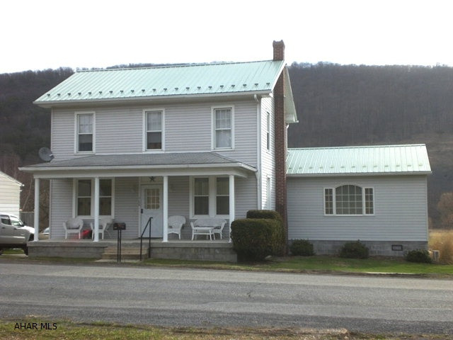 Exceptionally well maintained two-story home.  L/R, D/R, Kitchen w/new antique white cabinets, first floor master bedroom suite w/master bath.  Master bath has two showers.  Two more bedrooms and a den or bedroom and full bath on second level.  Full walk-up attic, 100-amp electric, walk-out basement, rear porch w/trex decking and front porch,  1-car detached garage, concrete driveway, oil hot water heat and a great view off the back porch.  This property needs nothing!