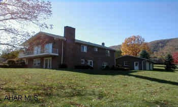 Well built brick home on lovely 1.5-acre site and only 2 miles from town.  Sunken living room w/FP; formal dining room; eat-in kitchen w/ pantry, laundry area; family rm. w/FP and new "French" doors; 2 garages (3 car-cap)