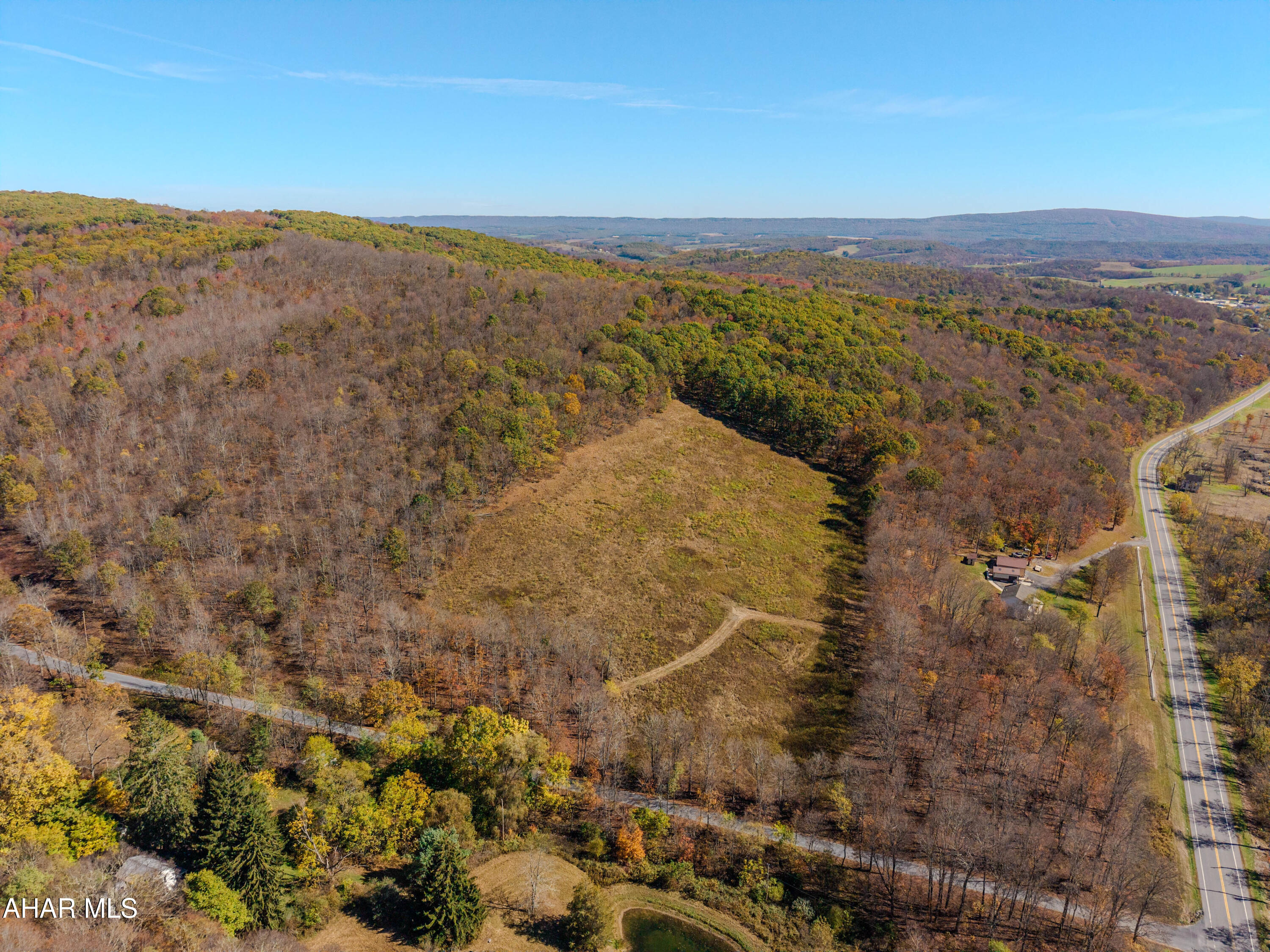 Are you looking for land in the Chestnut Ridge School District for recreation or a building site?  Come take a look at this 35.4 acre parcel.  This mostly wooded lot has been perc tested.  There is a cleared area of about 6 acres ready for your new home.  It has gently sloping to up sloping topography.  An electrical line runs through the property, making it easy to get electricity to your building site.  There is already a driveway leading to the field. The possibilities for this land are boundless.  Come and take a look, you just might want to make it yours.  This parcel can be purchased together with the 17.3 acre neighboring parcel. Taxes listed are based on the entire property.  The tax office will be updating the taxes. Survey will be made available as soon as the listing agent receives it.  Contingent on subdivision approval.