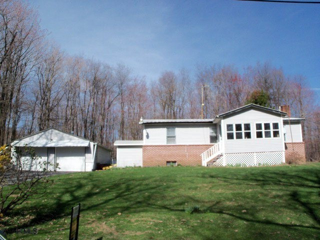 Well maintained ranch style home near Bedford County line. Two enclosed porches, detached 2-car garage, several sheds, walk-out basement, built-ins in Dining Room. Close to trout fishing and State Game Lands.