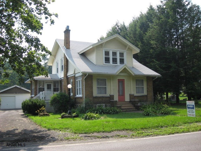 Charming brick/vinyl home on large 151x124. Lots of charm with the original woodwork, brick fireplace and French doors. New windows, upper roof replaced last year and chimney repointed. Side  deck. 1st floor bedroom or family rm. Enclosed front porch. Lots of closet space.  Garage will need overhead door to make it a two. Very well maintained home. Sellers will be hooking up to public sewer.