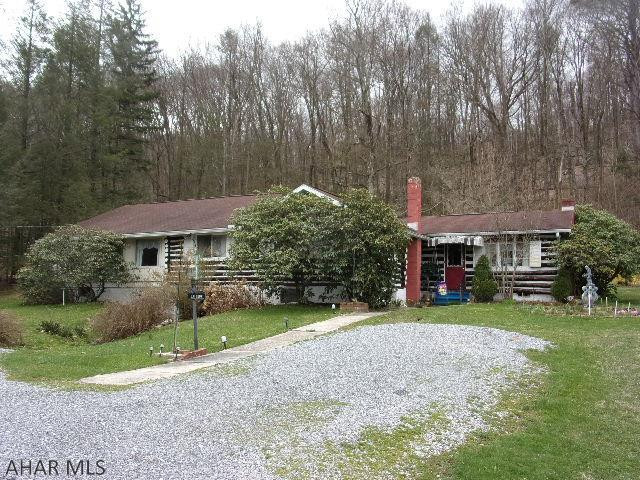 Unique property.  Original log cabin with addition.  Beautiful lot with flowering trees.  Nice setting.   Lots of space for additional bedrooms.