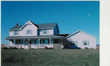 Country 2-Story 4 bedroom home with beautiful view, large level lot, wrap around porch and attached garage.