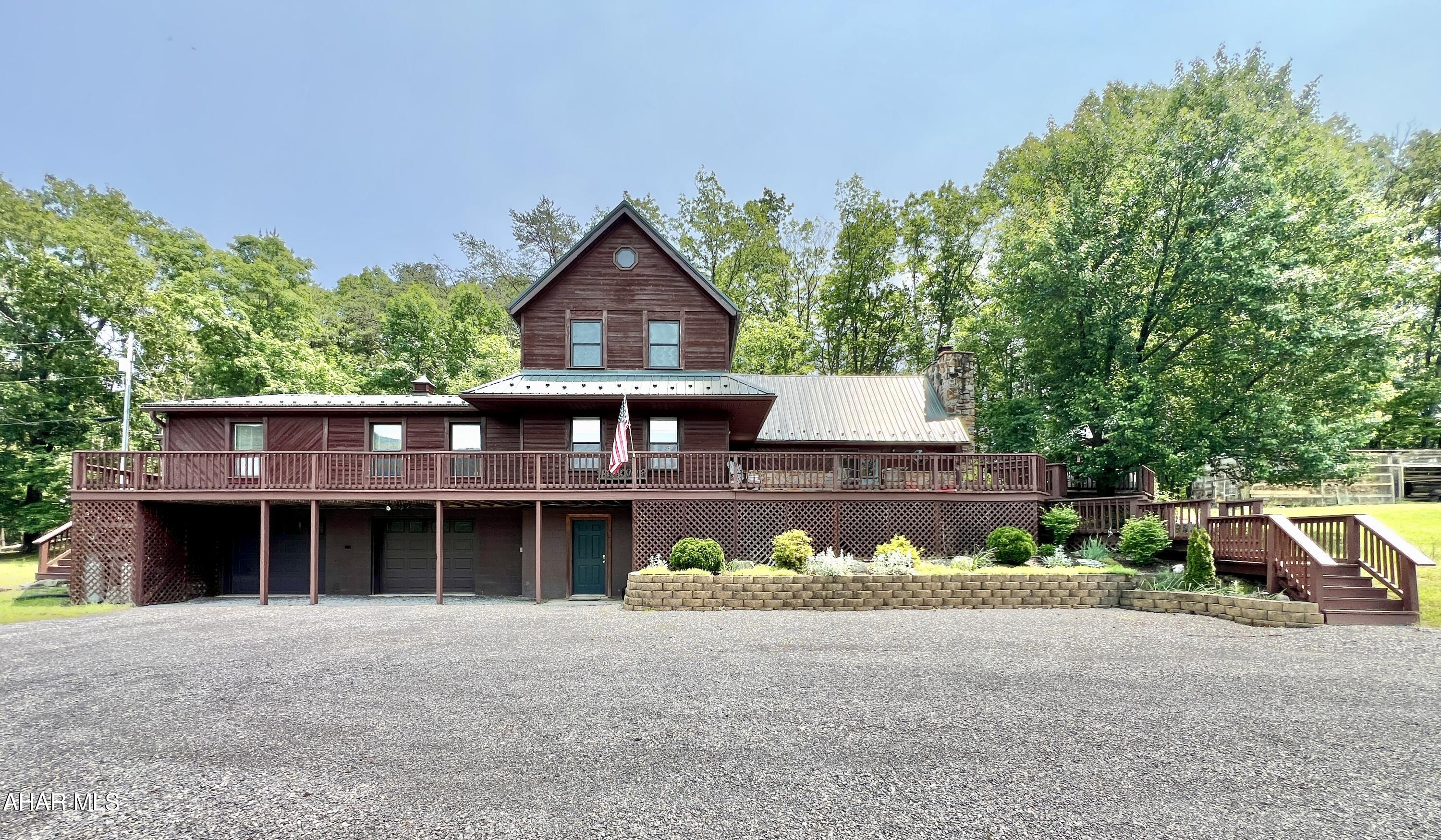 Beautiful custom-built cedar home with stunning views! Enjoy mountain living at its best in this spacious home on over 8 private acres.

The main floor features a welcoming Great Room with an impressive natural stone fireplace and cathedral ceilings, a dining room, and a kitchen—with a breakfast bar, stainless steel appliances, and granite countertops—plus French doors leading to the family room. The master suite includes a propane fireplace and access to a private three-season porch. An extra bedroom, half bath, and another three-season sunroom add to the home's versatility.

Upstairs, you'll find a second master suite, an additional full bathroom, and a charming loft overlooking the Great Room's stone fireplace. The walk-up, partially finished attic offers additional storage or expansion opportunities, while the walk-out basement with a large integral two-car garage, workshop, laundry area, and storage space enhances functionality.

Step outside to enjoy the wraparound deck that showcases the picturesque views and is perfect for gatherings and outdoor living. The property features an outdoor stone BBQ area, an above-ground pool for summer fun, an approximately 15x40-foot barn with a cement floor and three small animal stalls, a large 8x40-foot enclosed woodshed, over 20 assorted fruit and nut trees, and ample open areas for gardening and recreation. Hunt on your own land or in multiple nearby PA and MD State Lands, plus enjoy nearby fishing in both Flintstone and Town Creek.

Close to I-68, this home is located just 10 minutes from Rocky Gap Casino, Resort & Golf, as well as Buchanan State Forest and the PA Mid-State Trail. It provides an ideal escape to nature with easy access to amenities and outdoor adventures.
