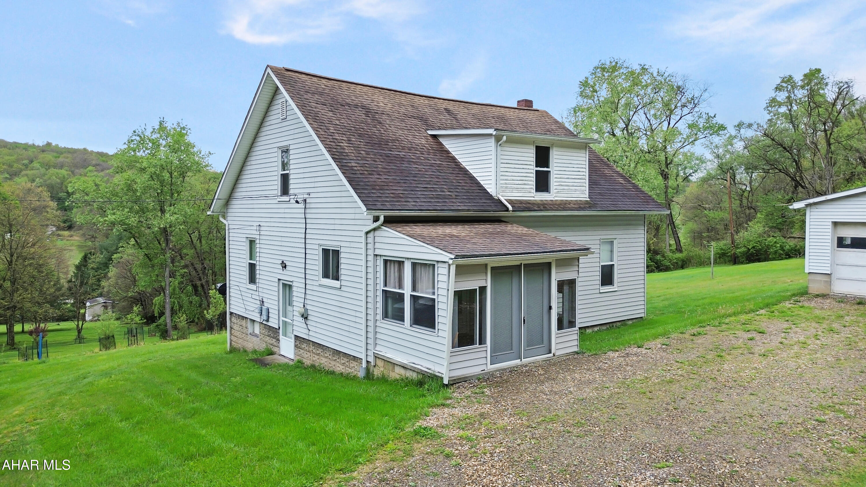 Welcome to 127 Squirrel Hill Road in the Ligonier Valley School District. Tucked away on a private dead-end road and surrounded by State Game Lands, this charming Cape Cod offers exceptional privacy, scenic views, and direct access to the outdoors. The main level features a spacious living room, dining area, and an updated kitchen complete with included appliances. You'll also find a convenient first-floor bedroom, a full bathroom, and a generously sized laundry room. Upstairs offers three well-sized bedrooms, each with walk-in closets and ample storage throughout. The unfinished basement provides additional storage space and houses the home's mechanicals. Outside, enjoy a large yard, breathtaking views, and a detached two-car garage. With direct access to State Game Lands, this property is perfect for outdoor enthusiasts or anyone seeking peace and privacy. Call today to schedule your private tour!