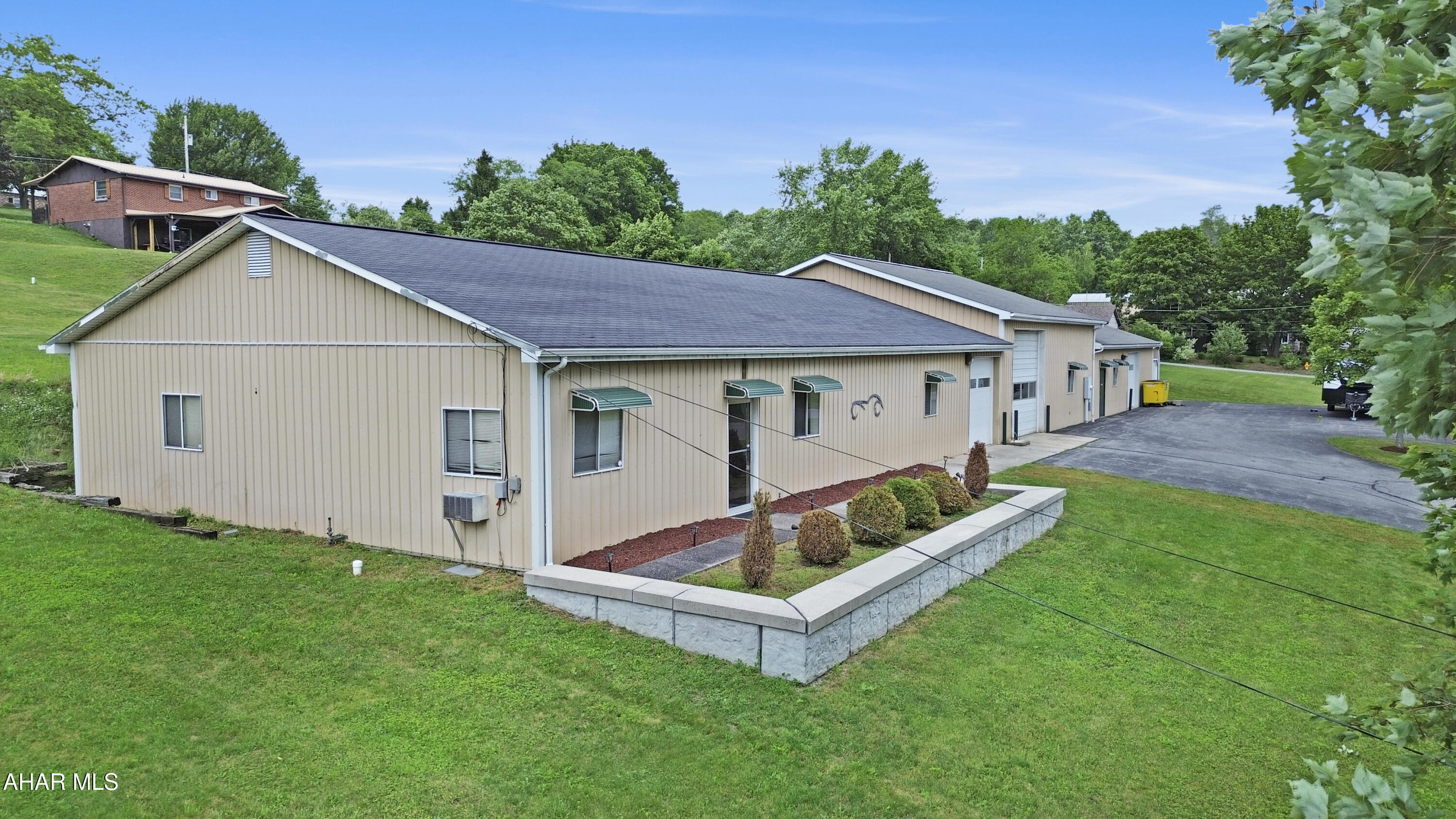 Welcome to 625 Shady Lane in Paint Township - an exceptional commercial opportunity offering approximately 6,160 square feet of versatile space in an area with no zoning restrictions. This well-maintained property is ideally suited for a variety of business, automotive, manufacturing, storage, or contractor-related uses. The front portion of the building features a welcoming lobby, dedicated office space, restroom, mechanical room, and additional storage areas. The expansive shop area boasts a professional paint booth, large open work bays, two 12-foot manual overhead doors, and one 14-foot automatic overhead door, providing excellent functionality for a wide range of operations. Additional highlights include oil forced-air heat, central air conditioning, electric baseboard heat in the office area, natural gas service available to the building, and compressed air lines conveniently run throughout the facility. Rarely does a property offering this combination of size, condition, flexibility, and accessibility become available. Call today for additional information or to schedule your private tour!