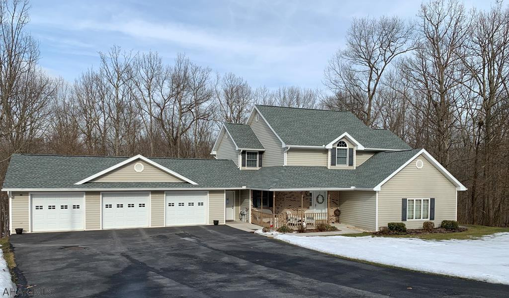 "Captivating"  2 story home with 3 bedrooms, 3 baths, 3 car garage on 3/4 acre lot on a gentle hillside with beautiful views of the woodland landscape.  Eat-in kitchen, Oak kitchen cabinetry, quartz countertops, ceramic tile flooring, pantry and French doors leading to the deck and a formal dining room with hardwood floors  just off the kitchen. The living room features a stone gas propane fireplace.  The spacious master suite offers his and her sink, walk in closet, separate shower area and soaking tub. On the lower level features a den/office recreation room, exercise room, work shop and a storage shed/garage for your tools and lawn mower and a patio.  The oversized 3 car garage. Plenty of storage through out the home.  Immaculate Home!!!