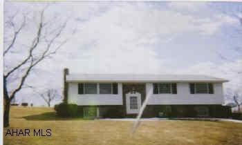 Lovely bi-level, family room with woodstove, landscaped lot, shed and workshop.