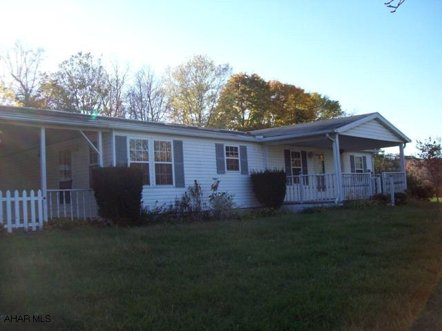 Oh the possibilities. Single family or investment property. This large three bedroom doublewide has a kitchen w/ a breakfast nook & island, a stone fireplace in the living room & a full unfinished basment. There is also a three car garage w/ an apartment above (originally used as an office) that could be a guest suite or additional income.