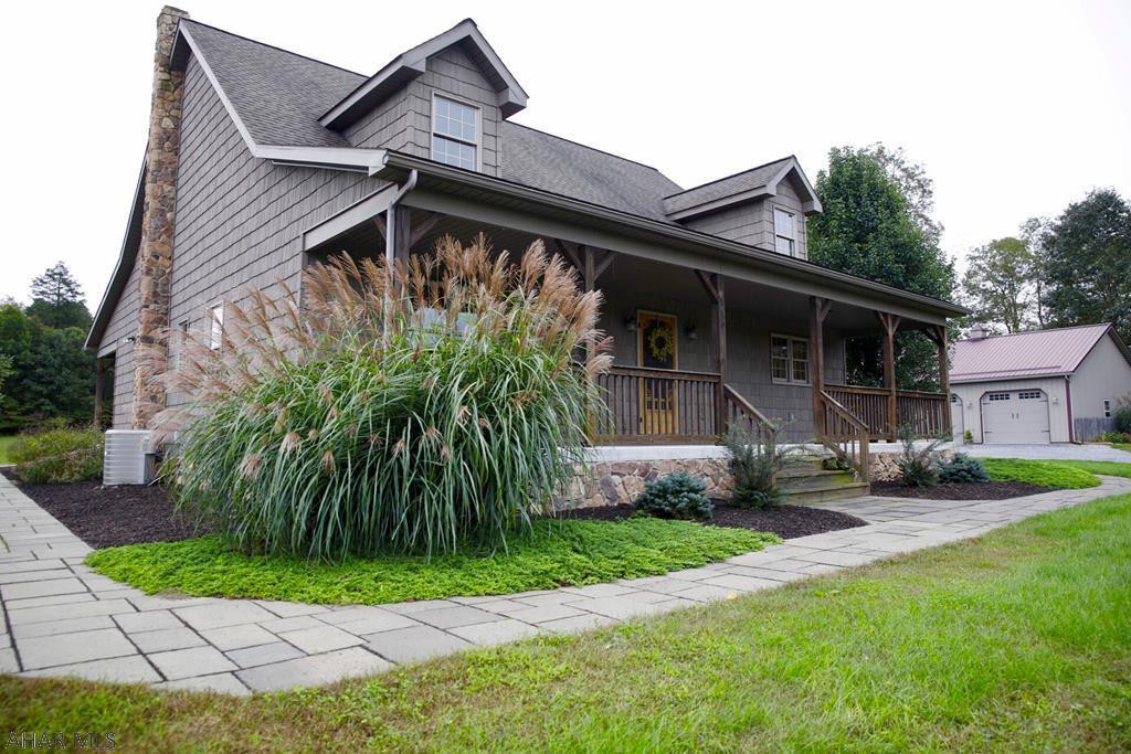 Don't miss out on this hard to find property. Built in 2006, vinyl shingles, detached 28X42 garage w/heat/water/electric/cable. The home is simply charming. Entirely surrounded by a cement sidewalk, has relaxing covered front and back porches. Includes 6.07 acres of privacy w/ abundant wildlife sightings. Inviting fire pit area recently built off the back porch. Inside has main level laundry room, kitchen cabinets are hard maple and the entire house is custom built. Yellow pine tongue and groove ceilings, white oak hardwood floors. Pellet stove in living room, central vac system as well. 2 bedrooms on main floor and master is complete with full bath, another full bath outside 2nd bedroom. Loft area that could be a 3rd bedroom. Full unfinished basement with endless possibilities.