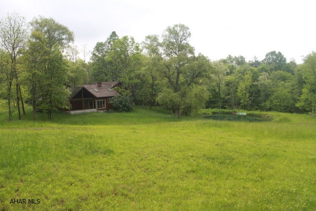 202 Acres of privacy and views.  Adjacent to Buchanan State Forest, this secluded retreat offers extensive renovations with new windows, multiple skylights and vaulted ceilings.  Cozy corners and an open floor-plan allow for many options in usage of the space.  An eat-in kitchen with views of an untouched meadow with spring fed pond below are truly remarkable.  A large main-floor bathroom with radiant floor heat and a master bed and bath loft add to the uniqueness of the property.  Additional workspace in the 24x42 garage and workshop easily house the 1930's Ford Tractor that is included with the sale. A low maintenance exterior adds significantly to the property's enjoyability.  Mature trees throughout the acreage are ready for timbering.  A property that can be enjoyed quickly and easily