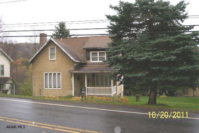 2 BR Cape Cod with large 2 car garage on 109 x 183 lot. Public water & sewage