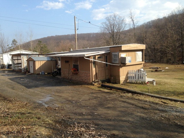 Older singlewide on nice lot - could live in singlewide or tear down and build. Private well and sand mound.