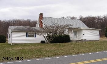 Handsome 1.5 story vinyl, 3BR/1BA house on 3+acres of open, level land, fenced for animals. Garage/barn/shop outbuilding Central air, thermal windows, newer oil FA furnace, 200 amp service, large rear porch, quiet location.