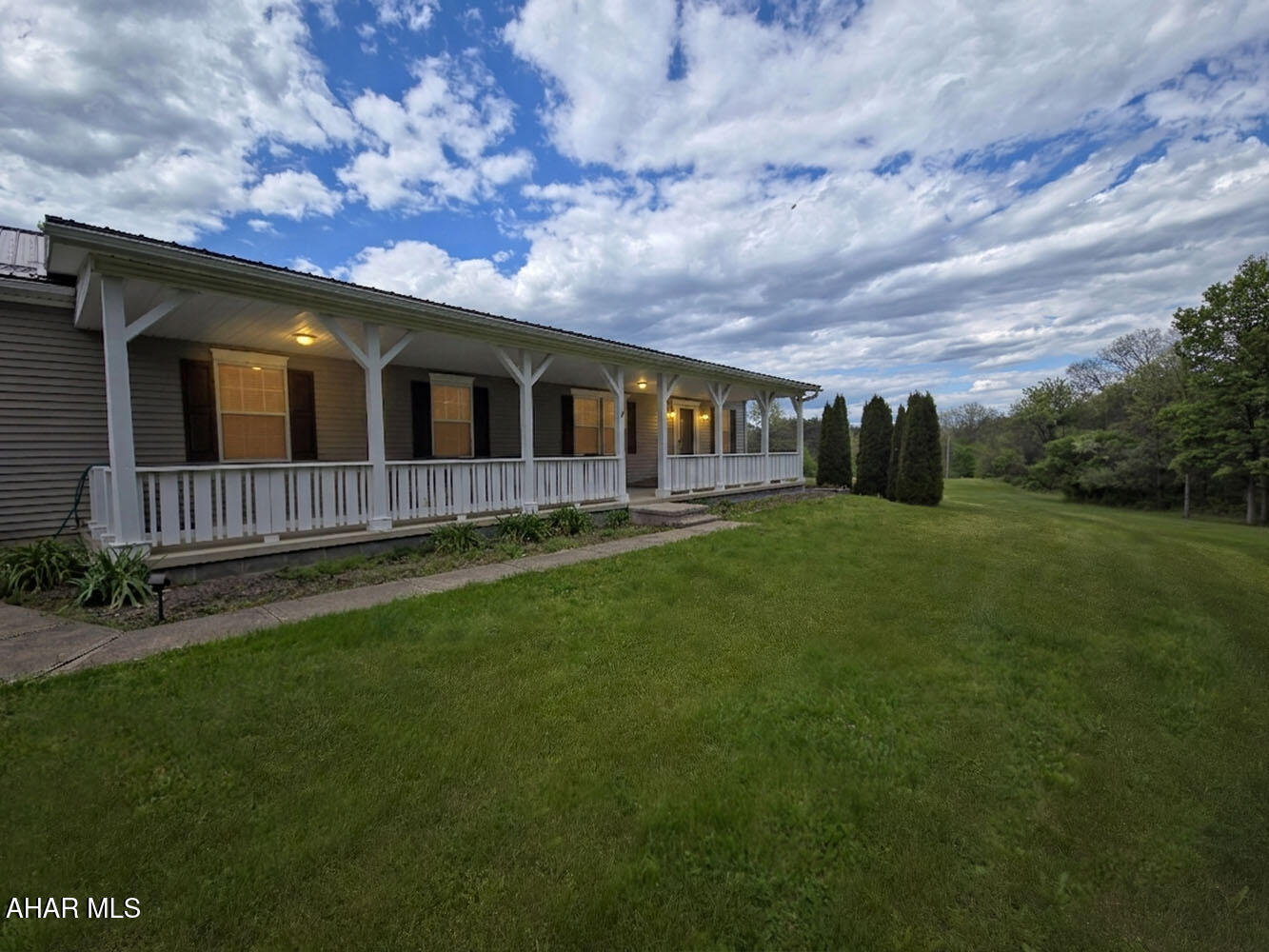 Welcome to 16958 Hidden Springs Lane in Shirleysburg, a spacious ranch-style home set on approximately 8.56 scenic acres with room to relax, entertain, and spread out. This property offers 4 bedrooms and 3 full bathrooms, including a finished lower level with its own bedroom, full bath, kitchen, egress, and living space -- creating excellent potential for guest quarters, extended living, or possible ADU-style use, subject to local requirements.

The main level features a comfortable layout with a welcoming living room, formal dining room, and a bright breakfast nook off the kitchen. Large windows bring in natural light and peaceful views of the surrounding property, while the covered front porch provides the perfect place to enjoy the private setting. The home also features a new metal roof, adding durability, peace of mind, and long-term value.

The finished basement adds valuable flexible space and expands the home's functionality, whether used for recreation, guests, multigenerational living, or a separate living arrangement. The home also features geothermal heating and cooling, offering energy-efficient comfort and the benefit of lower utility costs.

Outside, the property truly shines with wide-open lawn space, wooded surroundings, and multiple garage options. A large 3-bay detached garage includes one oversized door, making it ideal for camper, boat, equipment, or large vehicle storage. There is also a separate 1-car detached garage for additional parking, storage, or workshop use.

With acreage, privacy, finished living space, energy-efficient systems, a new metal roof, and exceptional garage capacity, this Hidden Springs Lane property offers a rare combination of comfort, versatility, and country living.
