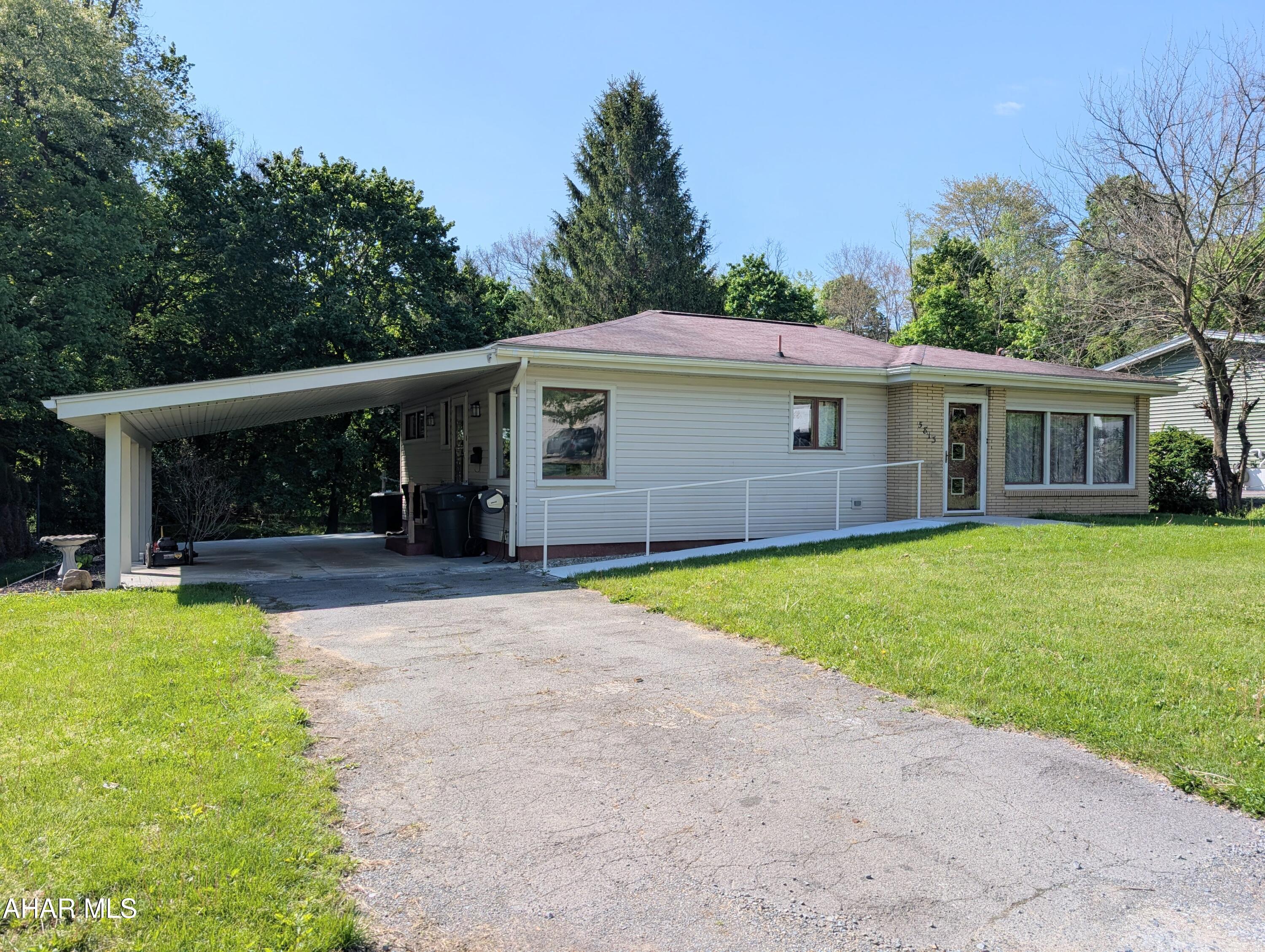Move-in ready single-story ranch living with a carport! RAMP ACCESSIBLE front entrance. Enjoy the lovely backyard on nearly 0.40 acres- open grassy space just off the carport, with beautiful mature trees providing shade across the back half of the yard. Huge winodws in the living room let in lots of natural light. There are refinished hardwood floors throughout and a fully updated kitchen. This home has a Natural Gas Central Air and Heating system, walk-in shower, and convenient first-floor laundry. Major maintenance and updates have already been completed, offering peace of mind and true move-in ready comfort!