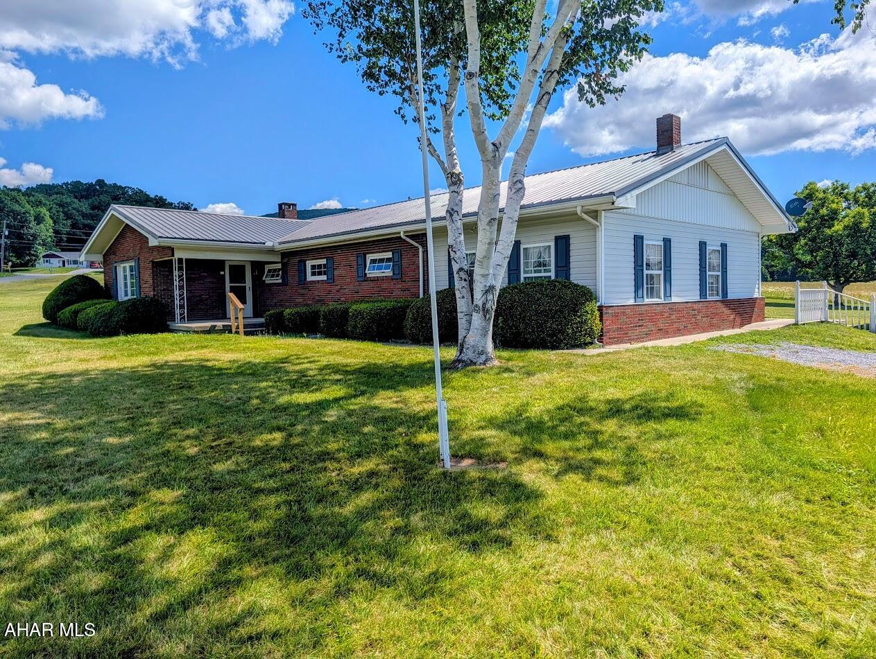 Welcome home to this well-maintained brick ranch situated on 2.647 acres in the Northern Bedford School District. Offering the convenience of one-floor living with additional finished space, this property provides the perfect blend of comfort, functionality, and country charm.

The main level features 3 bedrooms and 1 full bathroom with both a sunken tub and a separate stand-up shower. Enjoy gathering in the spacious living room or relax in the cozy family room highlighted by a beautiful stone fireplace. The eat-in kitchen offers ample cabinet space with attractive hickory cabinetry, making it both functional and inviting. A large laundry/mud room provides extra storage and serves as the perfect transition space from the outdoors.

Additional living space can be found in the finished recreation room, complete with a convenient half bath, making it ideal for entertaining, hobbies, or a home office. Step outside to the screened-in back porch and enjoy peaceful views of the surrounding property.

Recent updates include a new metal roof (April 2026) and replacement windows (approximately 15 years old), providing added value and peace of mind.

Outside, you'll find a detached 2.5-car garage along with a workshop, offering plenty of space for vehicles, storage, projects, or equipment.

If you're looking for a solid brick home with acreage, multiple living spaces, and excellent outbuildings in a desirable country setting, this property is one you won't want to miss. Schedule your private showing today!