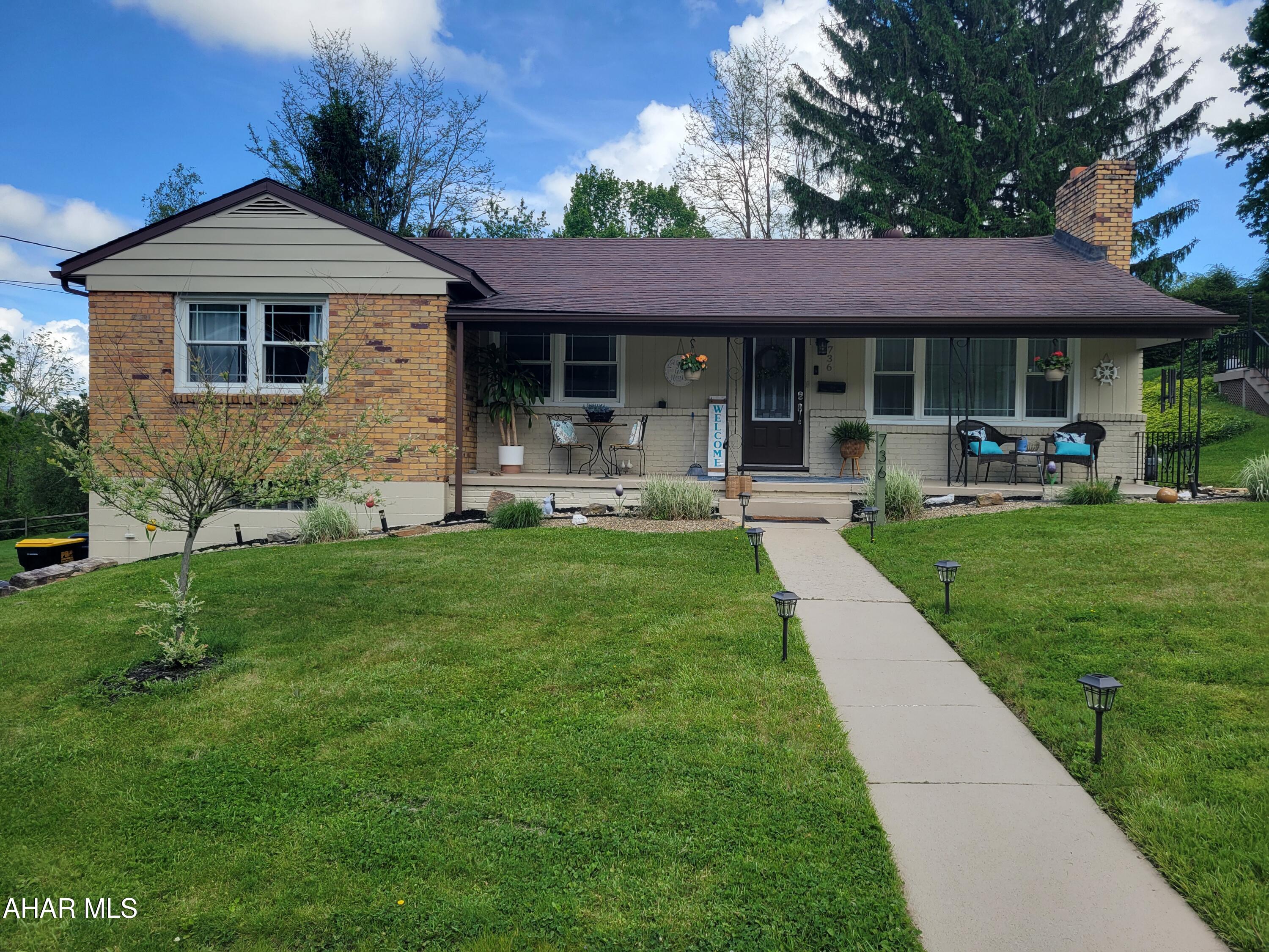 Tucked away on a lightly traveled street in Ebensburg, this thoughtfully updated three-bedroom mid-century modern brick home offers a rare blend of privacy, convenience, and timeless style. Set on an expansive double lot with nearby wooded surroundings, the property provides a peaceful setting while remaining just minutes from shopping, dining, recreation, and major travel routes.

Extensively updated throughout, the home features a beautifully renovated kitchen with handcrafted custom cabinetry, butcher block countertops, a striking 7-foot quartz island, quartz countertops, a marble tile backsplash, and all-new appliances (2022). A fireplace serves as the focal point of the open-concept living area, adding warmth and character while enhancing the flow between the home's main living spaces.

Additional improvements include new windows, upgraded attic insulation, a new electric service head and meter with supporting wiring, and whole-house surge protection. The sunporch provides additional space for relaxing or entertaining, while the generous driveway offers abundant parking. Combined with the spacious double lot and natural surroundings, this meticulously maintained three-bedroom property offers a distinctive opportunity in a desirable Ebensburg location.