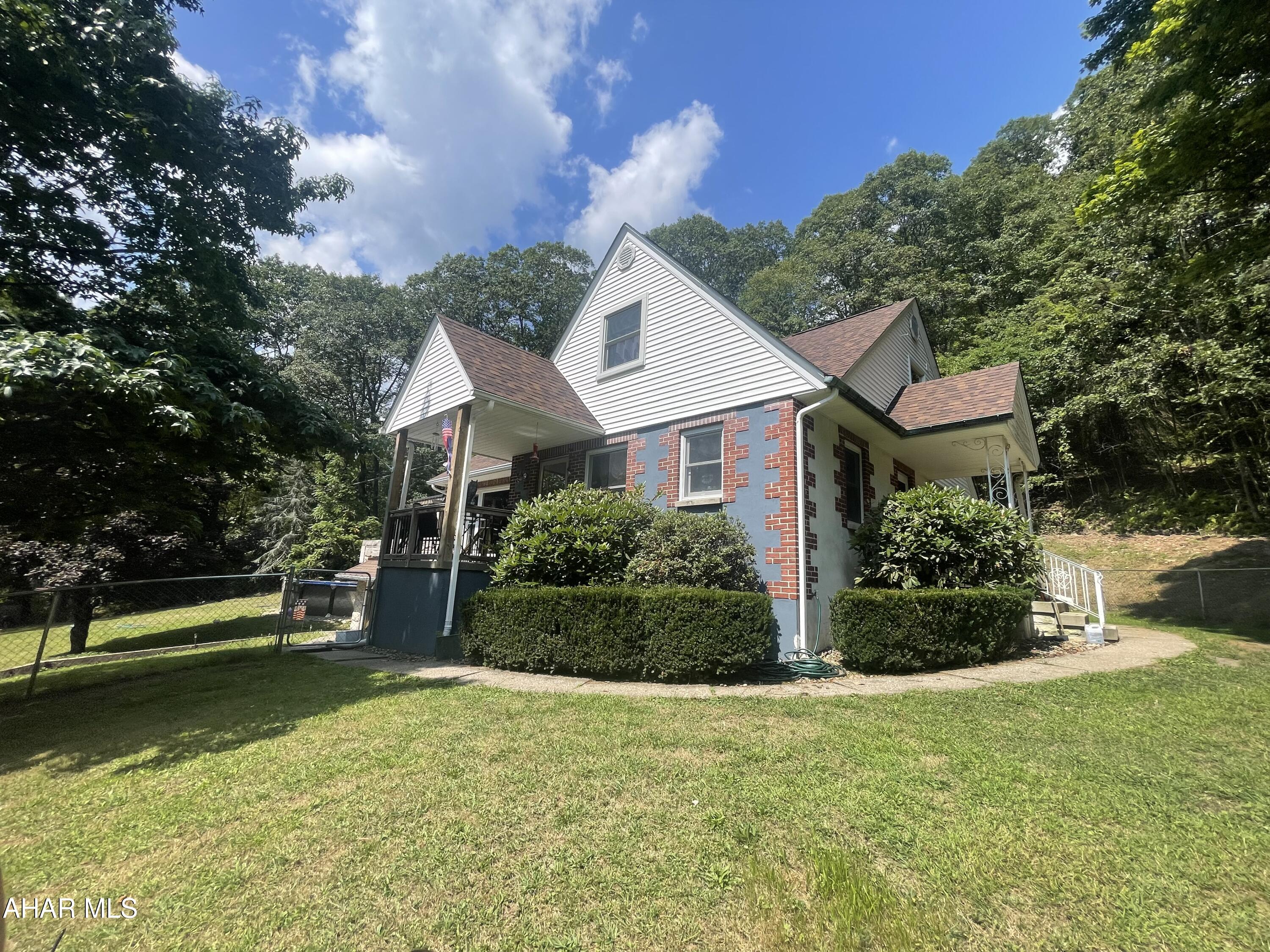 Looking for a peaceful country retreat? This charming home sits on 5.24 acres and offers the space and comfort you've been searching for. With 5 bedrooms and 2 full baths, there's room for everyone. Enjoy cozy evenings in the spacious living room with a fireplace and hardwood floors. The bedrooms are generously sized, and the outdoor living is just as inviting—relax on the patio with a hot tub and fireplace, or take a dip in the above-ground pool.

Recent updates include a new roof, mini splits and septic system, giving you peace of mind. The property also features a partially fenced yard, RV parking, and a one-car garage. Well cared for and move-in ready, this home blends country living with modern comfort.