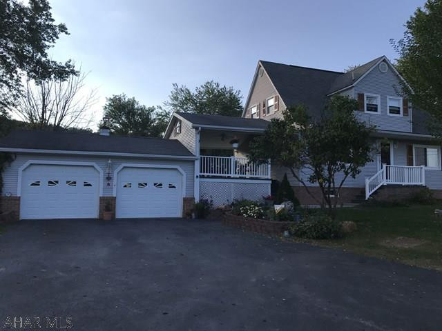 Imagine yourself sitting under the breezeway sipping your morning coffee or entertaining friends or family. This is a very well maintained and inviting two story home located in a country setting yet only minutes from town. The home offers 3 bedrooms, hardwood floors, 2 bathrooms, heated two car garage,  finished basement with LP gas fireplace, two out buildings, one is a shed and the other a garage sized building, nicely landscaped and ready for you to call this charming property your home.