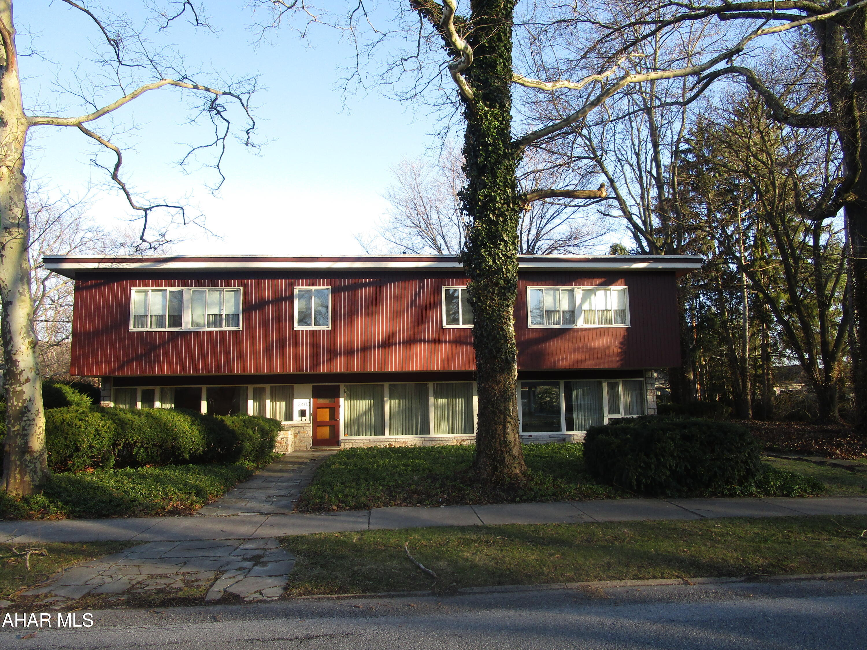 One of Blair County's most unique residences. this mid-century modern home is  located in historic Mansion Park.  Constructed of steel and concrete, the one owner home features an elegant sunken living room, formal dining room, den with wet bar, main floor laundry room with appliances.  Note marble windowsills throughout.  Six graciously sized bedrooms, three full baths and endless closets throughout the second floor.  Cozy hot water heating.  Private rear flagstone patio to enjoy the coming warm summer days.  Two car garage with additional storage and furnace room.