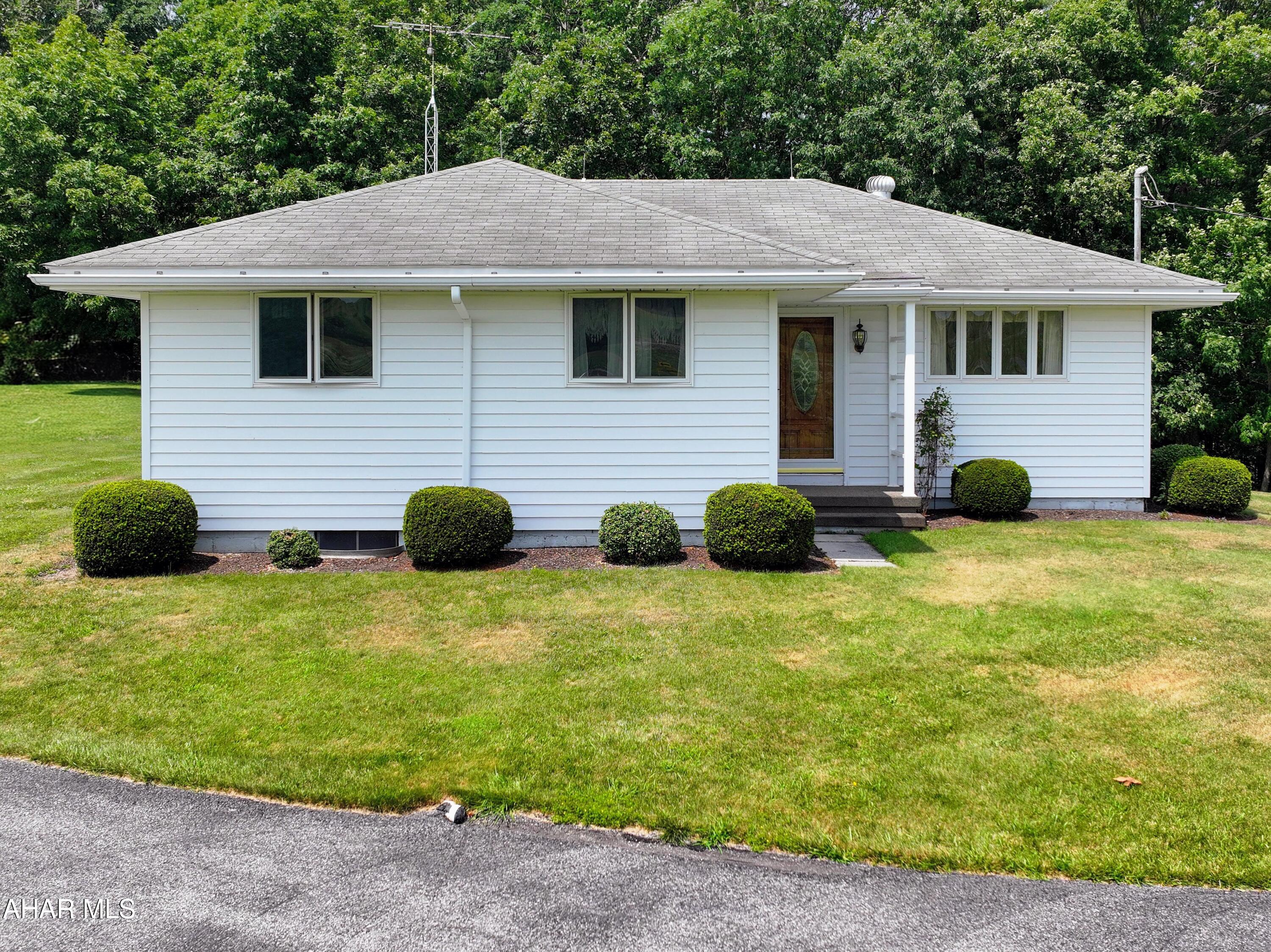Well-maintained ranch home situated on over 1 acre with stunning countryside views. The main floor features three bedrooms and one full bathroom, living room, dining room, and kitchen with oak cabinetry. The partially finished basement provides a large recreation area with a kitchenette, along with two storage rooms for added convenience. Outside, you'll find a heated 48' x 30' two-car garage providing ample room for vehicles, storage, and hobbies, plus two additional storage sheds.