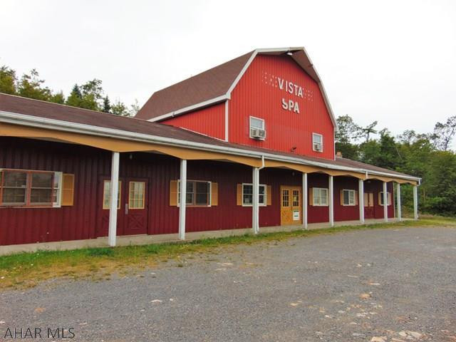 Here's a unique option for investors or someone looking for a project to make their own. This property possesses over 11 acres bordering I-70E. The house sits toward the back of the acreage and has a really incredible view of the surrounding mountains and valleys. 2 master bedrooms with attached full baths. Cathedral ceilings in kitchen/dining and living room areas. Bring your ideas and designs to this home and make it your own! A very large building is also included which was originally built as a flower distribution center. There are so many possibilities for this property! So bring your own business, or start a new one! Bring your collections to house in the large heated and cooled building and restore the house to the masterpiece it's meant to be! Priced to MOVE!!!!