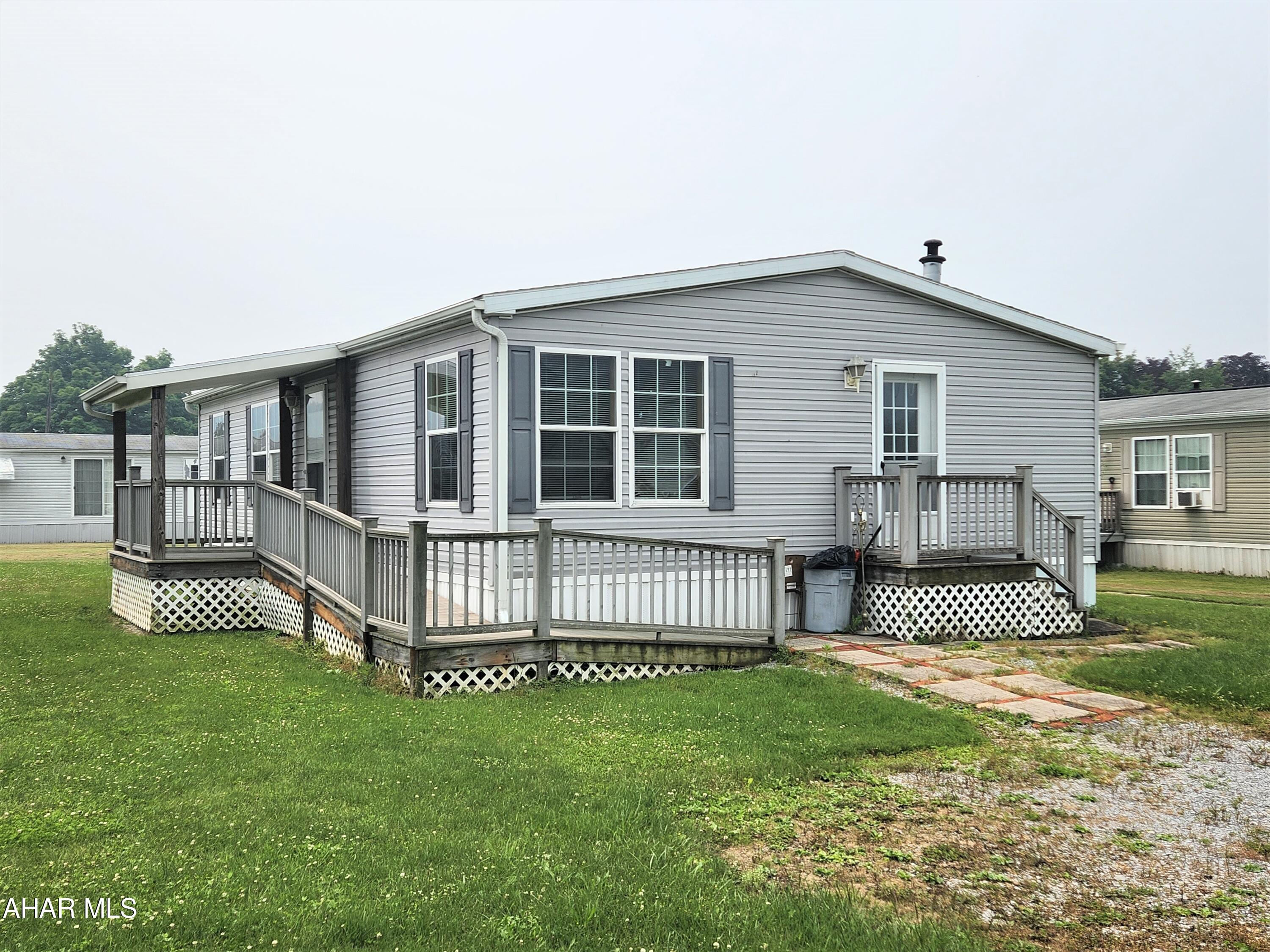 Are you looking for a move-in ready home with little outside work to worry about?  Then come take a look at this 2006 Champion double-wide mobile.  This home is move-in ready, has a large living room, an open concept kitchen with a dining area, a laundry area, 3 bedrooms and 2 full bathrooms.  The primary bedroom features a walk-in closet and en suite bathroom.  The side covered porch has a ramp and trex decking; no steps necessary to get inside.  Just a little bit of TLC is needed to make this your perfect home.  Property is on a rented lot.  Lot rent is currently $210 per month.  Buyer must be approved by lot owner for renting the lot.  Application and mobile home park rules are included in the document.  The mobile home park owners prefer lot renters to be age 55 or over.  No subletting of lot is allowed. 2006 Champion Model # SS922C
Serial #007-017088AB-000-H
HUD Label #'s PFS962351 & PFS962352
Date of Manufacture 04/11/2006