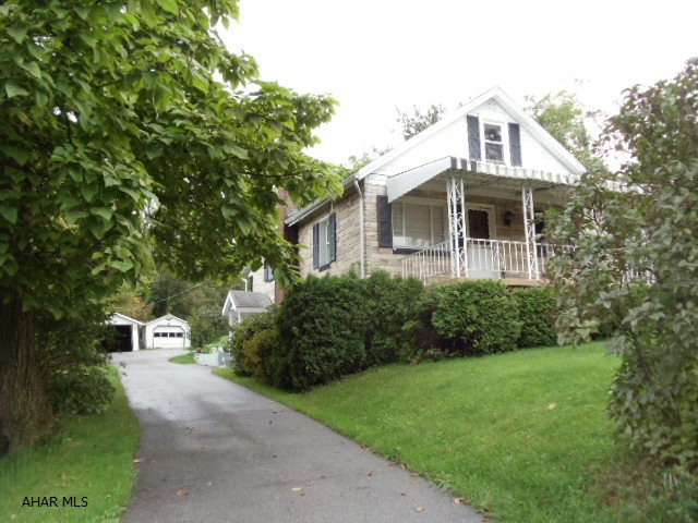 Peaceful setting! 1.2 acres w/3 Bedroom Cape Cod, stone veneer & aluminum siding, vinyl windows, modern eat-in kitchen, 1st floor modern bath w/new floor, 2-car detached garage plus attached shed & black top drive. Trees: 3 apple, 1 pear, 2 plum, grape arbor and blueberry bushes. J-097