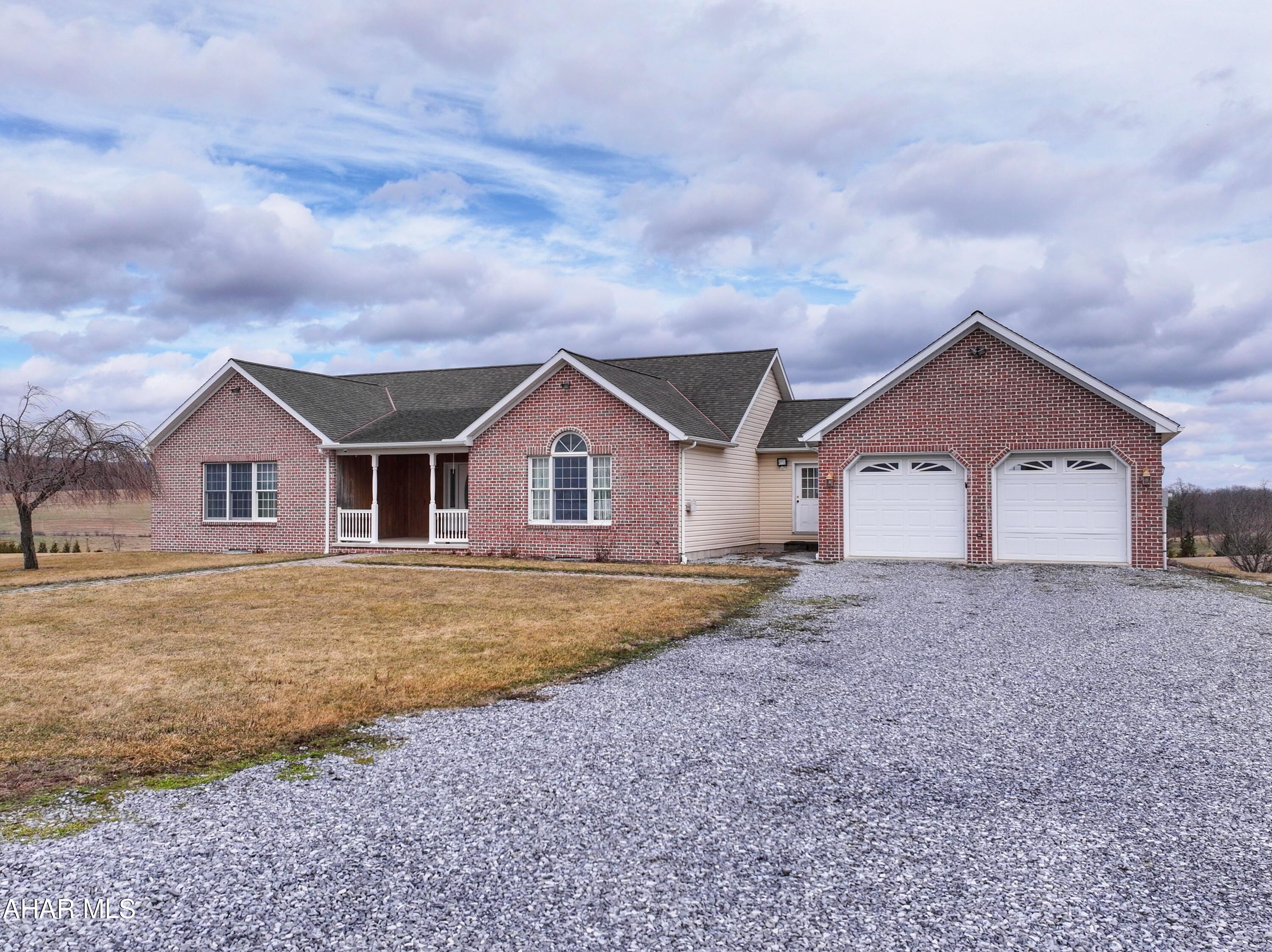 Well-maintained ranch home situated on over 2 acres with stunning panoramic countryside views. The main floor features an open and functional layout with three bedrooms and 2.5 baths, living room, formal dining room, and kitchen offering oak cabinetry and a breakfast bar that opens into the family room creating a great space for everyday living and entertaining. Laundry hookups are also conveniently located on the main floor. The partially finished walk-out basement provides excellent additional living space with a kitchenette, two bonus rooms suitable for bedrooms, ¾ bath, large recreation area, and a generous storage room with built-in shelving. Outdoor features include a recessed covered front porch and a composite rear deck, ideal for relaxing or entertaining while enjoying the scenic views. The attached 24' x 30' two-car garage provides plenty of space for vehicles and extra storage. Additional features include generator hookup, a Kinetico water system, central vacuum, and a recently replaced heat pump.
