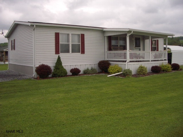 Very nice double wide on level rented lot.   Immaculate condition.  Nice landscaping.  Carport for 2 cars.  Detached one car garage with a workshop inside; can be used for storage.  Rent includes sewer and trash.  Tenant must be approved by land owner. This is an ideal home for a small family.  Bathrooms are handicap accessible.  Home is Type M, Wind Zone 1, Roof Zone 5.