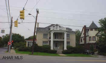Pillared brick beauty in Hollidaysburg borough, corner lot, music room and den.