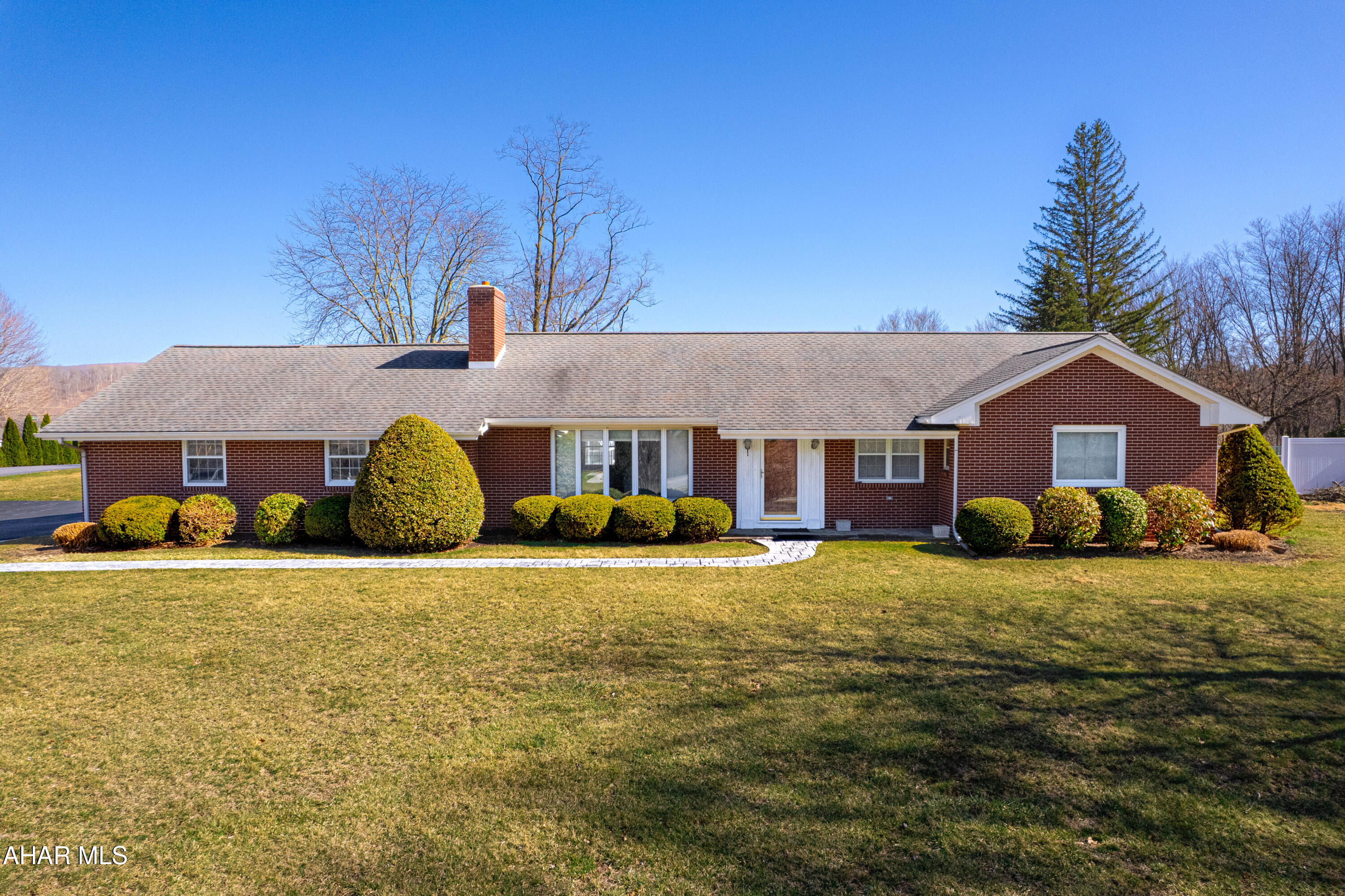 Welcome to this charming brick ranch home in the heart of Bedford, PA!! Just minutes from the downtown area but offering beautiful mountain views and a large 1.557 acre lot. The spacious main house features three bedrooms and two full bathrooms, large kitchen with pantry, a bright living room with a wood burning fireplace, dining area great for dinners and guests, and a convenient first floor laundry room. Finished basement with a large rec room and another wood burning fireplace. There is an unfinished portion of the basement offering a kitchen area that's perfect for canning all those fresh garden vegetables and offering ample storage. Hardwood floors, wood trim, replacement windows and 200-ampere electric. Two-car garage and a paved driveway. Attached to the main house is a fabulous in-law suite or guest quarters. This section of the home offers a living room, kitchen, sunroom, full bathroom and one bedroom. Outside you will find an in-ground swimming pool for all to enjoy and have fun on those hot summer days. Quality home in a terrific location!!