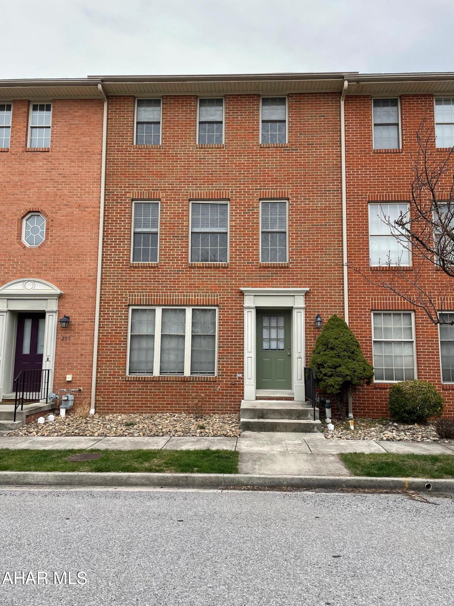 Don't miss out on this beautifully maintained townhouse in desirable Holliday Hills! Enter the main level to new, luxury vinyl floors and a living quarters that could serve as a family room or guest suite with a full bath available. Main level containing open kitchen with new appliances (air fryer oven!). Open living room and dining room area offers beautiful hardwood floors with a half bath completing the main level. Both bedrooms include large closets, and full bath contains pocket door and plenty of storage. Convenient laundry chutes on main and second floor. Central air and off street parking. The Holliday Hill townhouses offer a playground and picnic area perfect for spending time outside! Call today for your private showing before it's too late!