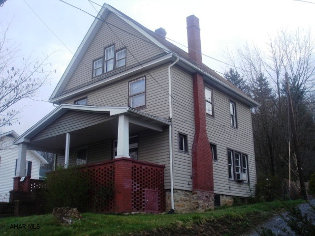 Solid home with hardwood trim and floors. Nice fenced yard in back. Brick Wood burning fireplace in Living Room. Third floor is large finished space. Home needs some TLC but has great potential. 1 car garage.