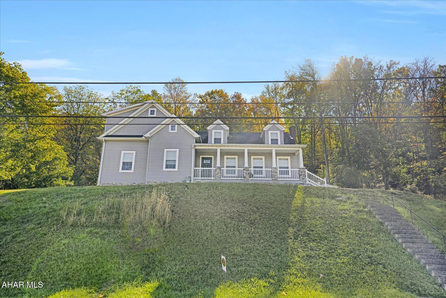 This meticulously remodeled and expanded 2 story residence offers inviting curb appeal, featuring a covered front porch with picturesque views of the surrounding mountains. The rear of the property boasts scenic woodlands and unique, regionally rare plantings, complemented by an attractive stamped patio for relaxation.

Upon entry, a spacious foyer provides a convenient built-in cabinet and ceramic tile flooring. The hallway leads to a lovely half bathroom. To the right, a versatile room is suitable for use as an office, family room, den, or other purposes. On the left, the bright living room with spacious coat closet, seamlessly connects to an expansive dining area, which includes double doors opening to the patio and backyard. Adjacent to the dining area, the kitchen is equipped with modern cabinetry, an island, and newer appliances. A well-designed laundry/mudroom is located off the kitchen, enhancing household convenience.

The second floor is accessed from the front staircase. At the top, to the right, there is a well-lit bedroom with a dormer window and ample natural light. A full bathroom is situated at the landing. To the left, a flexible bonus area currently serves as a playroom but can be adapted for various needs. Further along the hallway is a generously sized second bedroom with a large closet. The primary suite is located at the front of the home, featuring a private bathroom and substantial storage space.

This property combines comfort and functionality with close proximity to numerous amenities and represents an exceptional opportunity.