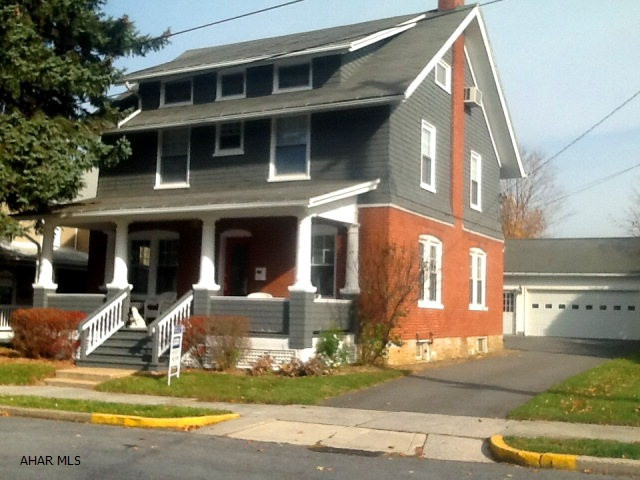 Traditional style white pillared brick/cedar shake shingle home of distinction. Beautiful restored chestnut trim and flooring. Central air conditioning, in-law suite, new kitchen and bathrooms, stain glass window complete w/ white picket fence and covered front and back porches. Add'l parking and 2-car garage is close to everything and in a great location of town. Absolutely gorgeous move-in ready home.