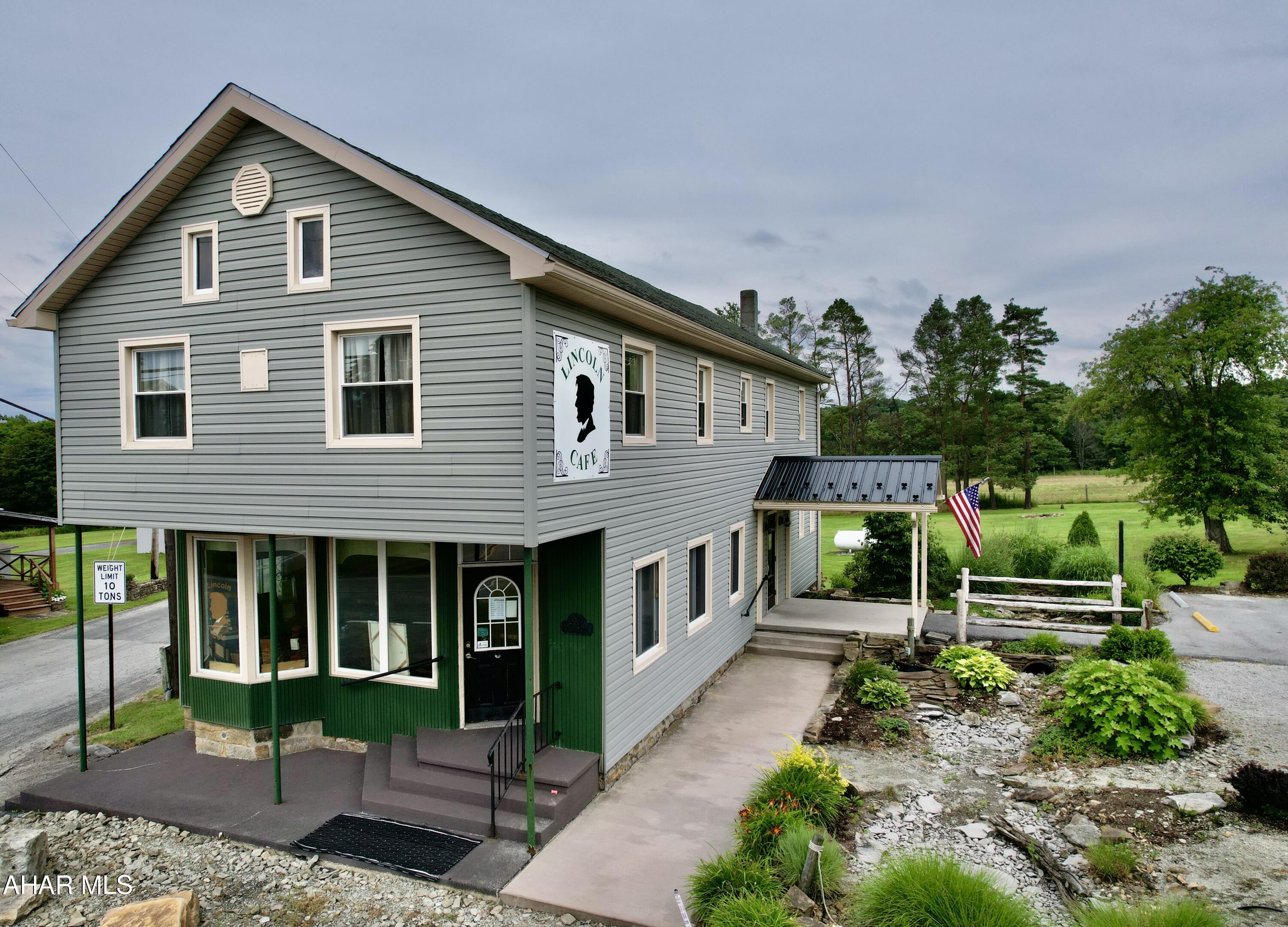 LOCATION, LOCATION, LOCATION.  Just 1.5 miles East of the Flight 93 Memorial National Park entrance along the historic Lincoln Highway where hundreds of thousands of visitors come each year to visit, sits a profitable turn key business. Patrons from all over the world have enjoyed the food and atmosphere in the historic café.  This was once Buckstown's General Store and Post Office(which is still hanging inside the café today).  Large store front windows allow for tons of natural light in the dining area.  Patrons can sit and relax after visiting the Flight 93 Crash site and take in the horses from the nearby campground or the windmills across the street.  The café seats 50 comfortably inside with additional seating outside on the picnic tables if traveling with pets.  The manicured 1.5 acre corner lot with a shed and 2-car garage allows for expansion of endless possibilities. Vegetable/fruit/flower stand outdoors while patrons can take a break inside the café.  There is also an open BBQ pit covered by a aluminum roof at the back of the building.  The upstairs is an apartment with a shared office space.